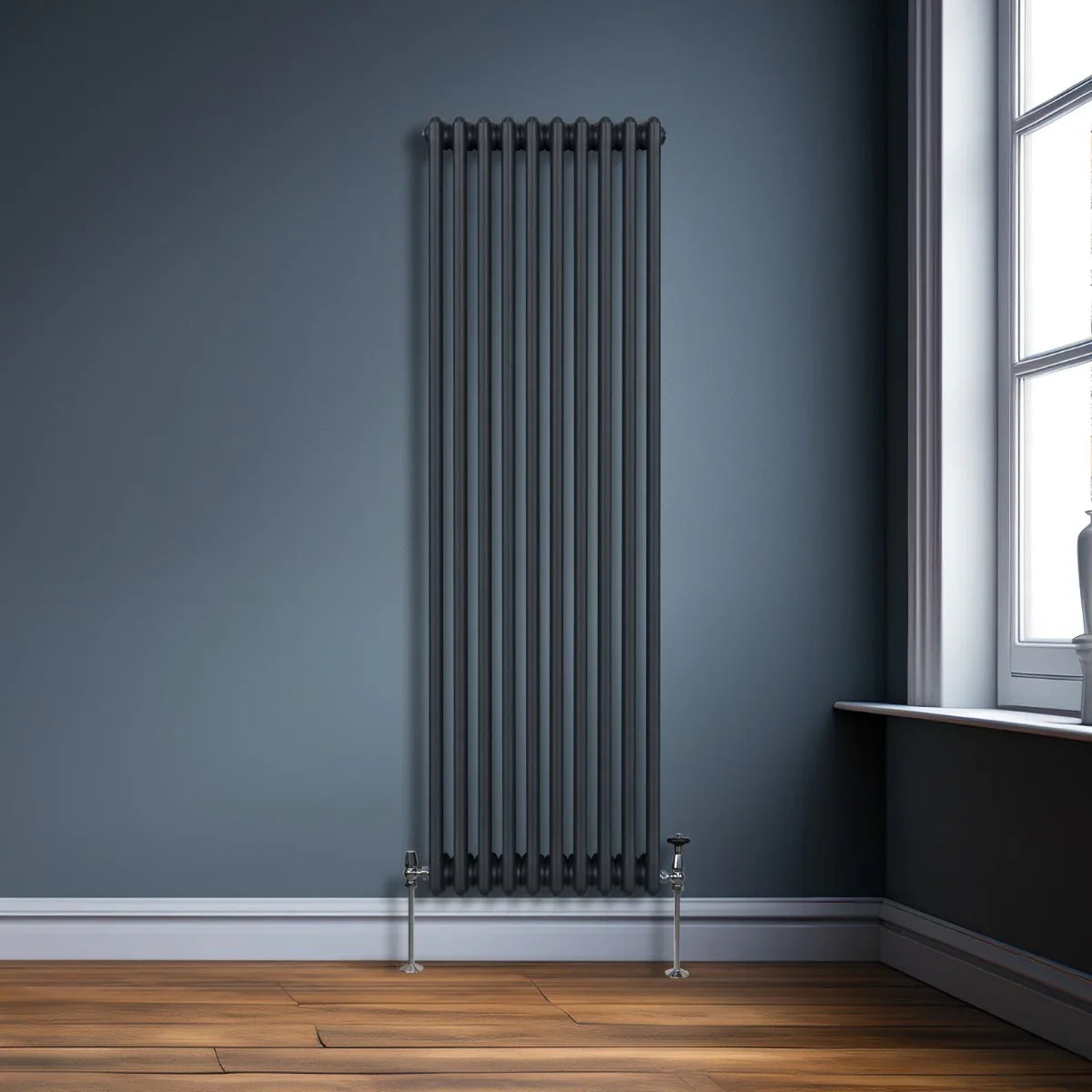 Traditional 3 column radiator in anthracite grey, featuring sleek vertical lines and a modern design against a dark wall