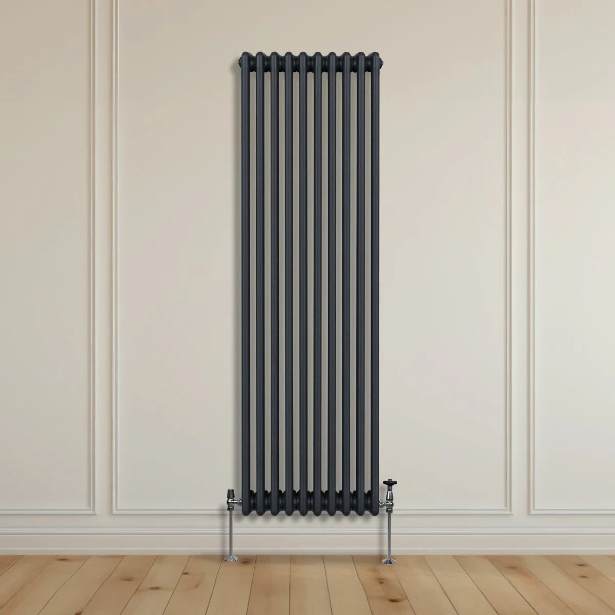 Traditional 3 column radiator in anthracite grey, featuring a sleek vertical design with a smooth finish, mounted on a wooden floor