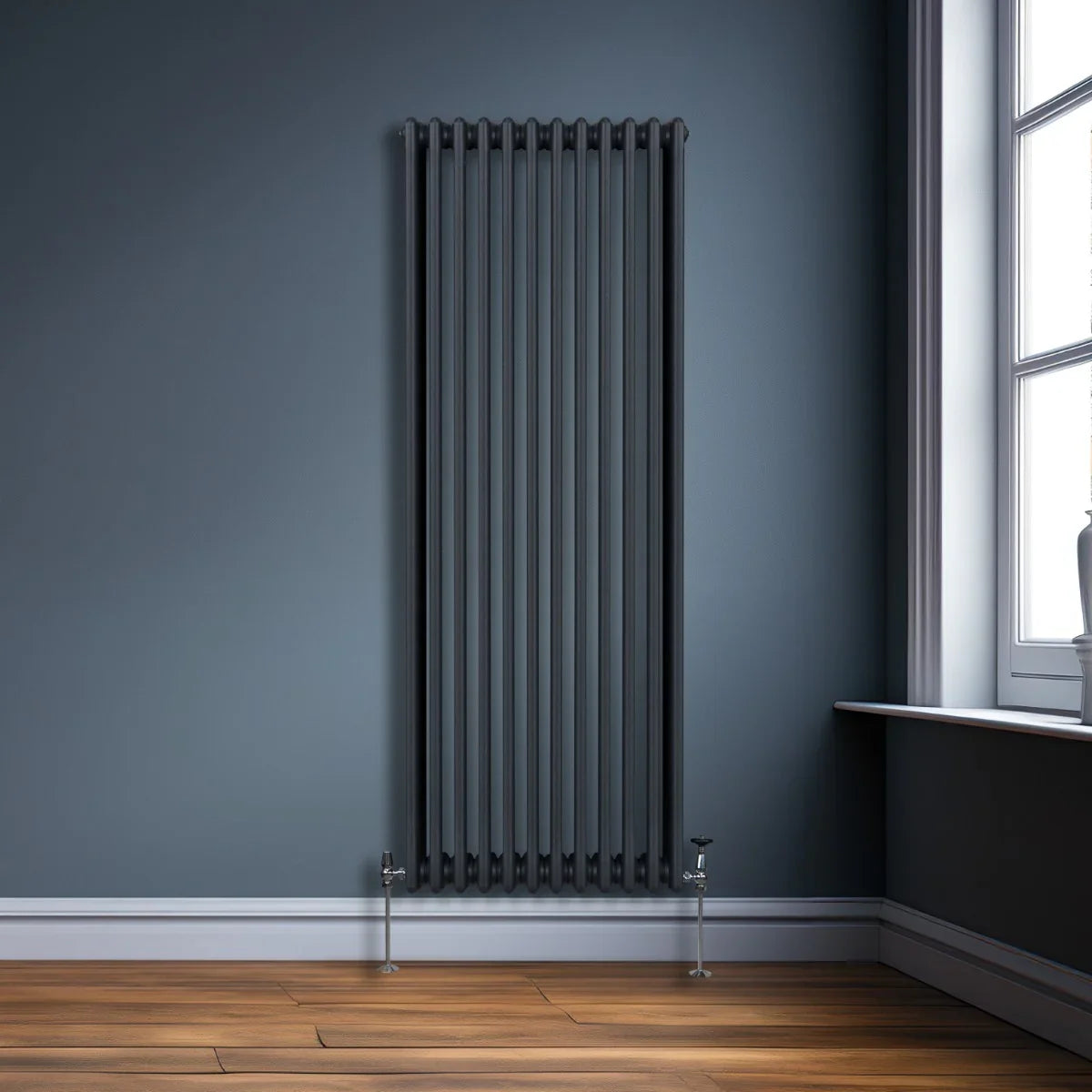 Traditional 3 column radiator in anthracite grey, featuring a sleek vertical design against a dark wall and wooden floor