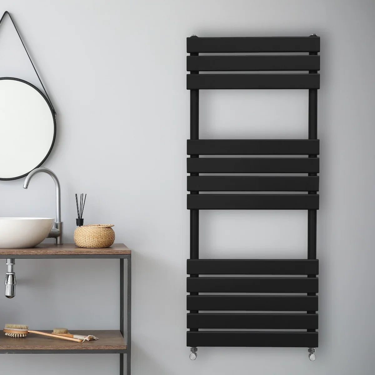 Sleek black flat panel towel radiator, 1200mm x 450mm, featuring horizontal slats, mounted on a minimalist bathroom wall