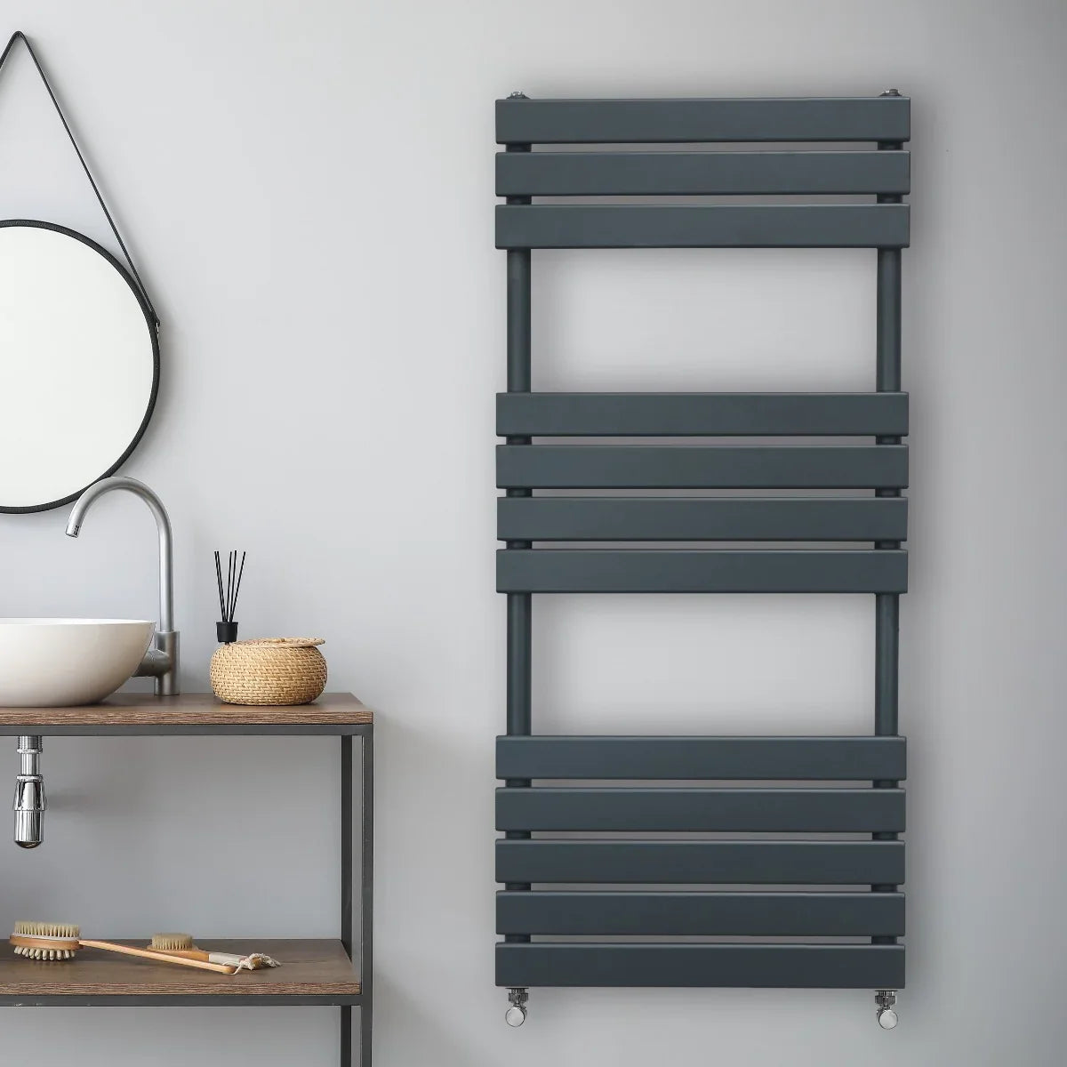 Flat panel towel radiator in anthracite grey, featuring a sleek, modern design with horizontal slats, mounted on a light wall