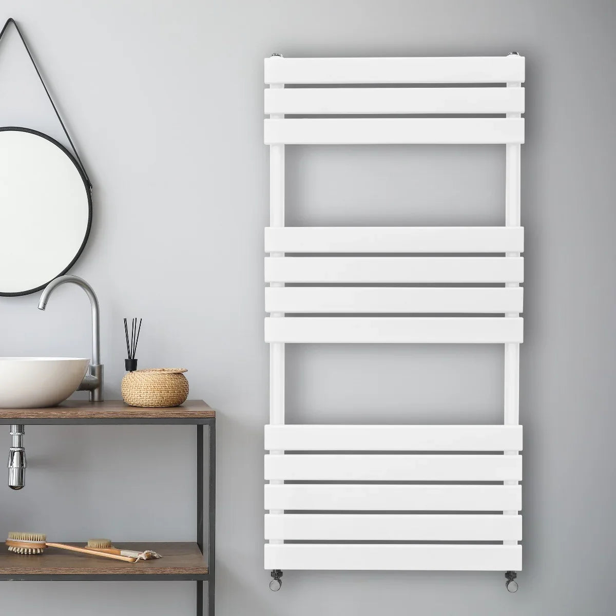 Flat panel towel radiator in white, featuring a sleek, modern design with horizontal slats, mounted on a gray wall above a wooden shelf