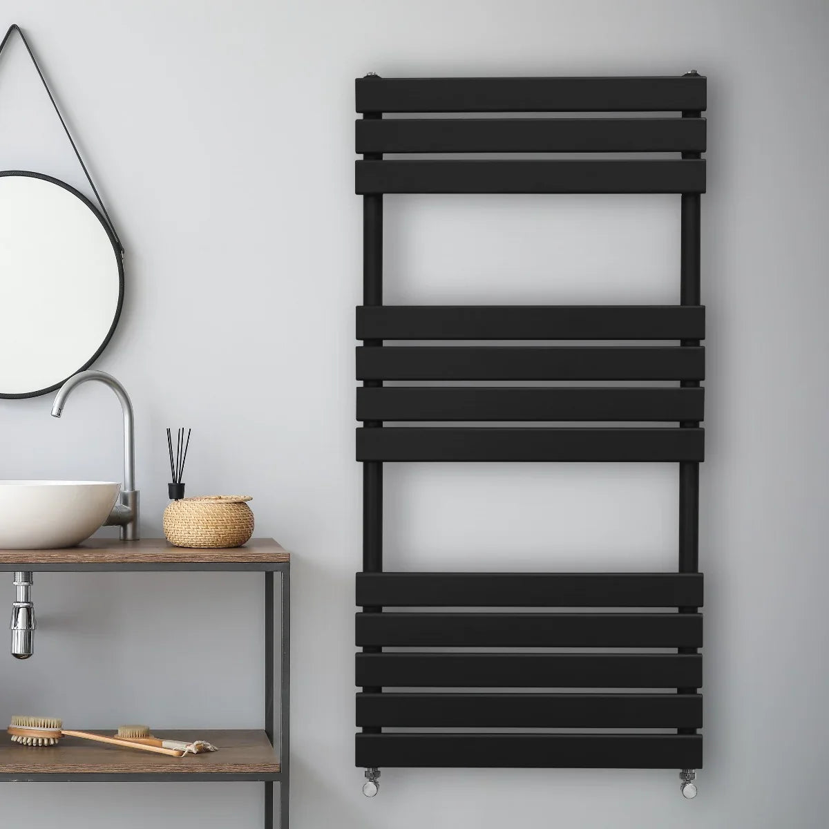 Sleek black flat panel towel radiator, 1200mm x 600mm, mounted on a light gray wall, enhancing modern bathroom decor with clean lines