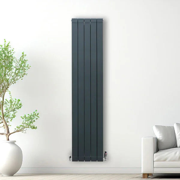 Slim anthracite grey aluminium radiator, 1800mm x 395mm, featuring vertical panels, mounted on a white wall beside a potted plant