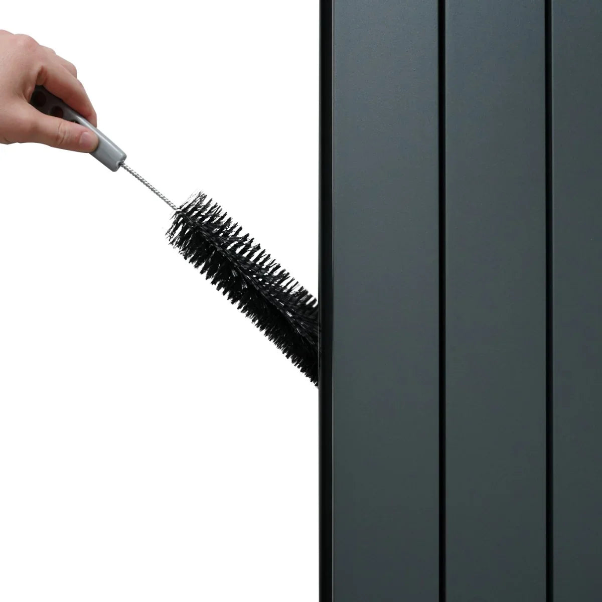 Anthracite grey aluminium radiator with sleek vertical panels, being cleaned with a brush for maintenance and optimal performance