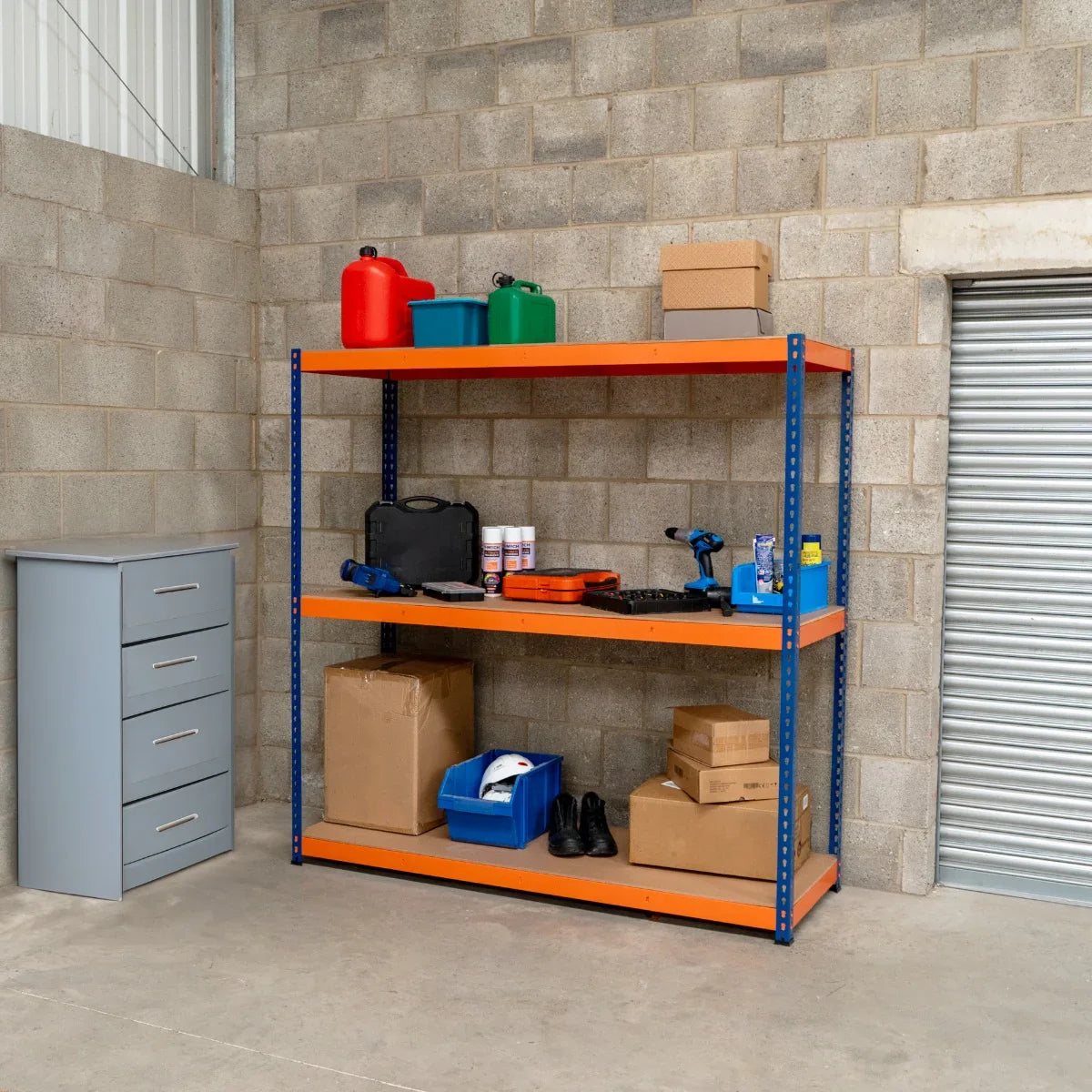 S-Rax 3 Shelf Racking in blue and orange, featuring sturdy metal shelves, filled with storage boxes, tools, and containers in a garage setting