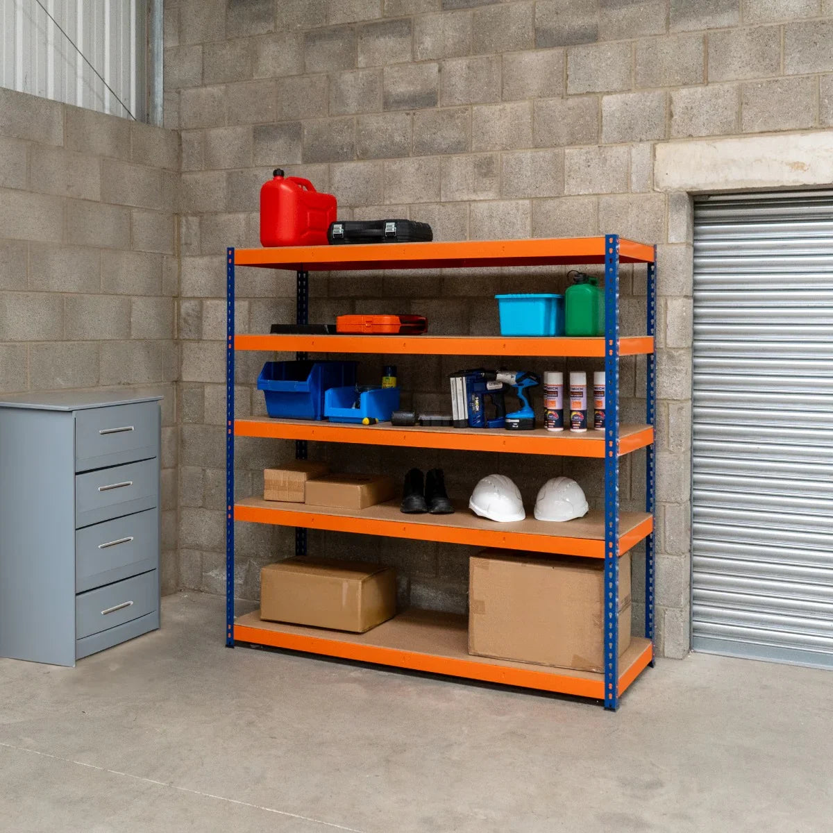 S-Rax 5 Shelf Racking in blue and orange, featuring sturdy metal shelves, organized tools, boxes, and safety gear in a warehouse setting