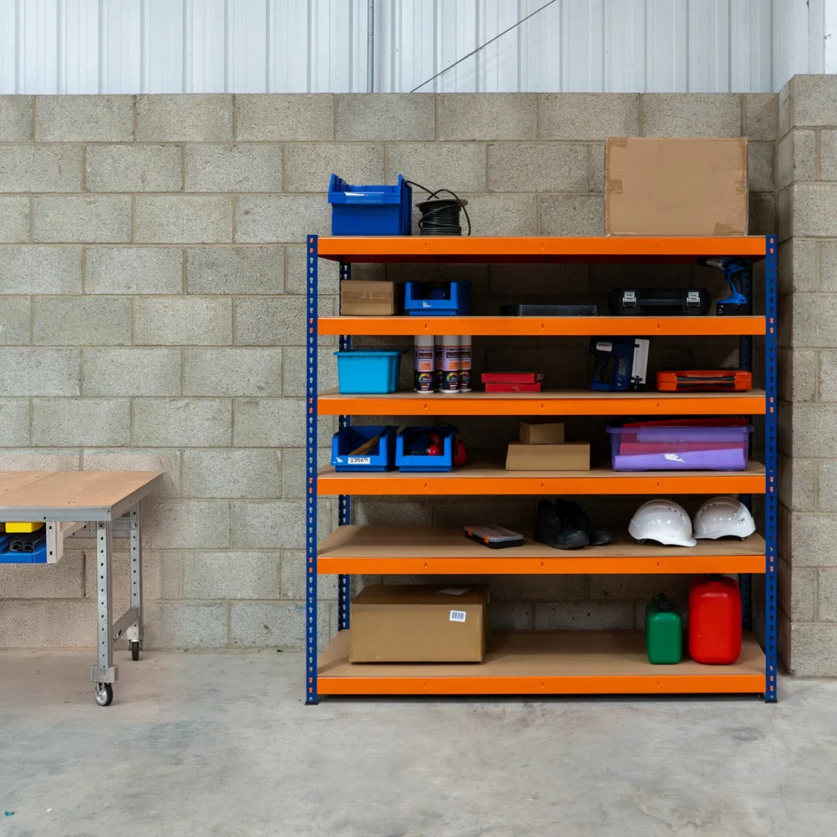 S-Rax 6 Shelf Racking in blue and orange, featuring sturdy metal shelves with assorted tools, boxes, and safety gear displayed on each level