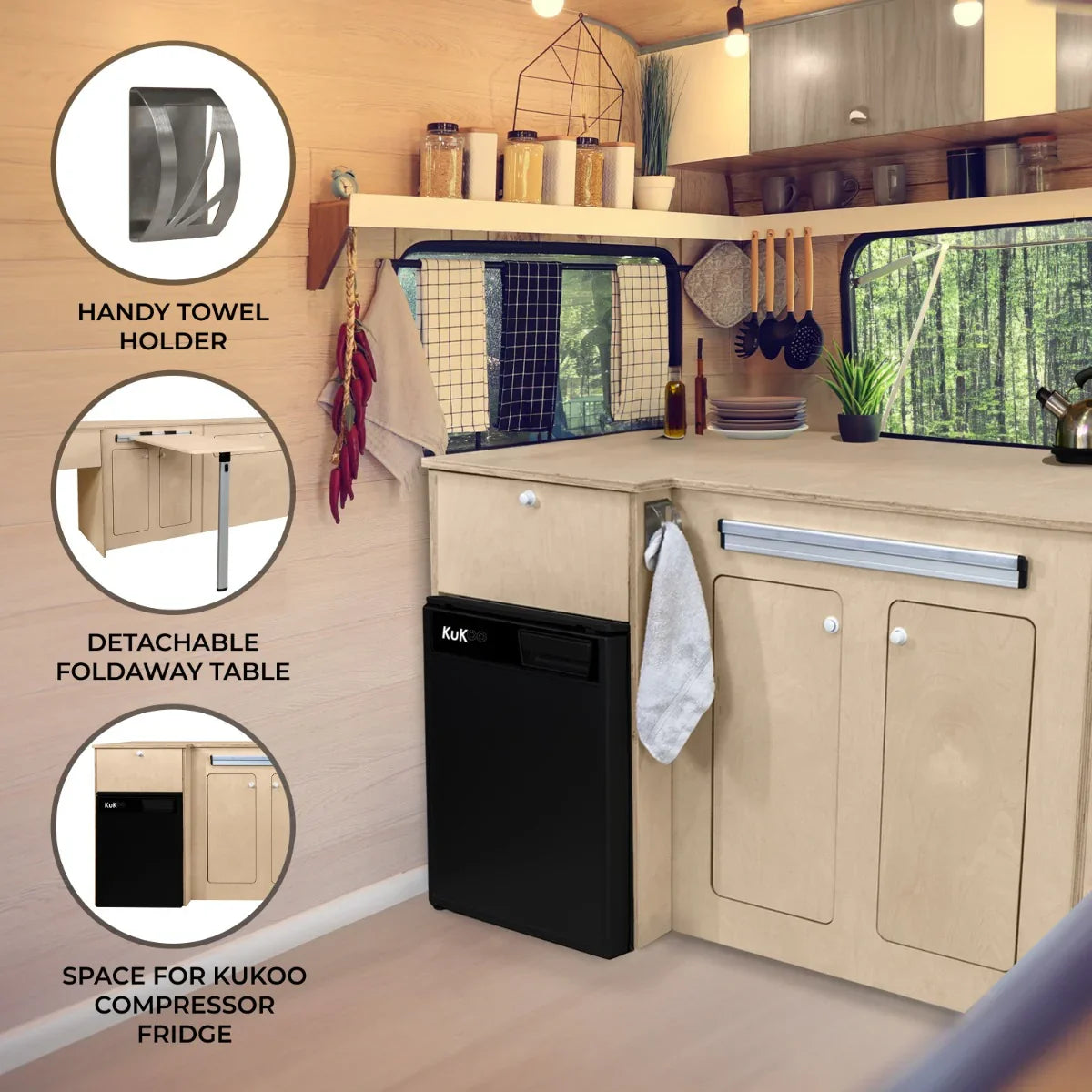 Camper kitchen pod featuring a black compressor fridge, wooden cabinetry, a foldable table, and towel holder in a cozy interior setting