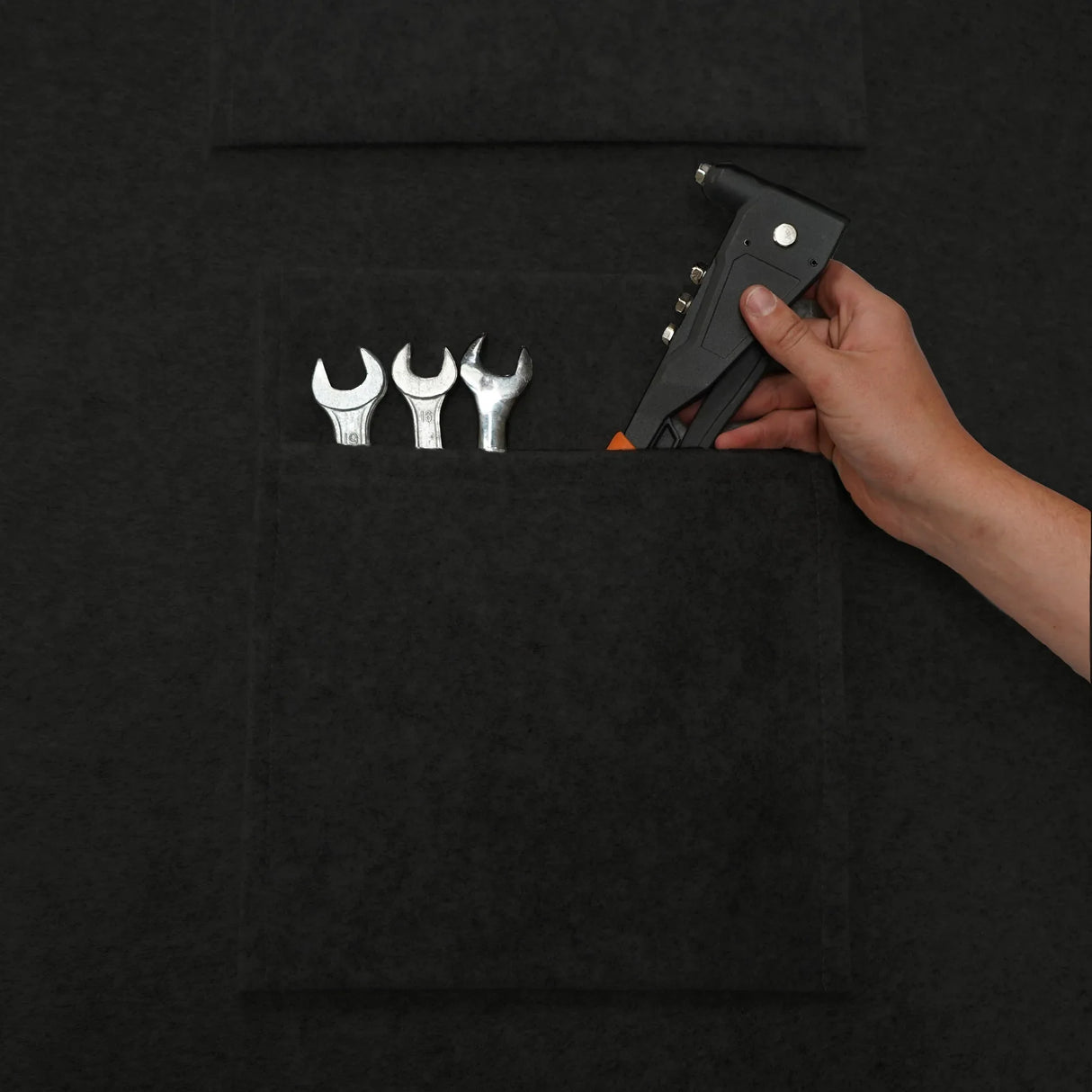 Black van carpet lining with storage pouches, featuring tools like wrenches and a hand-held gun for easy organization and access