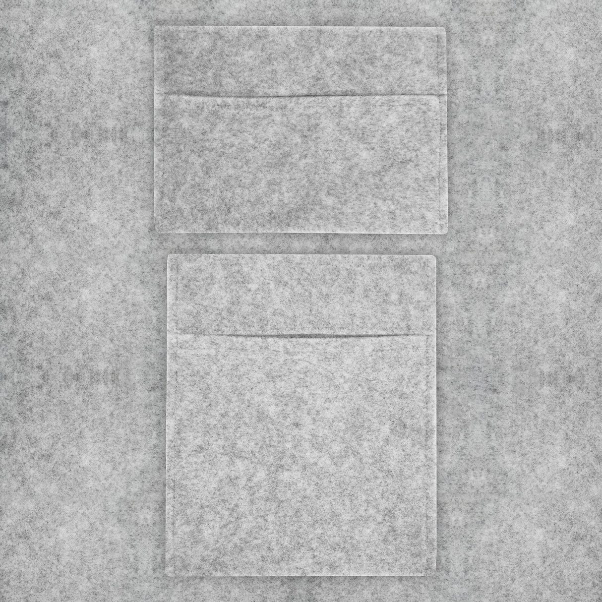Silver grey van carpet lining with two storage pouches, featuring a soft felt texture and sleek rectangular shapes for organized storage
