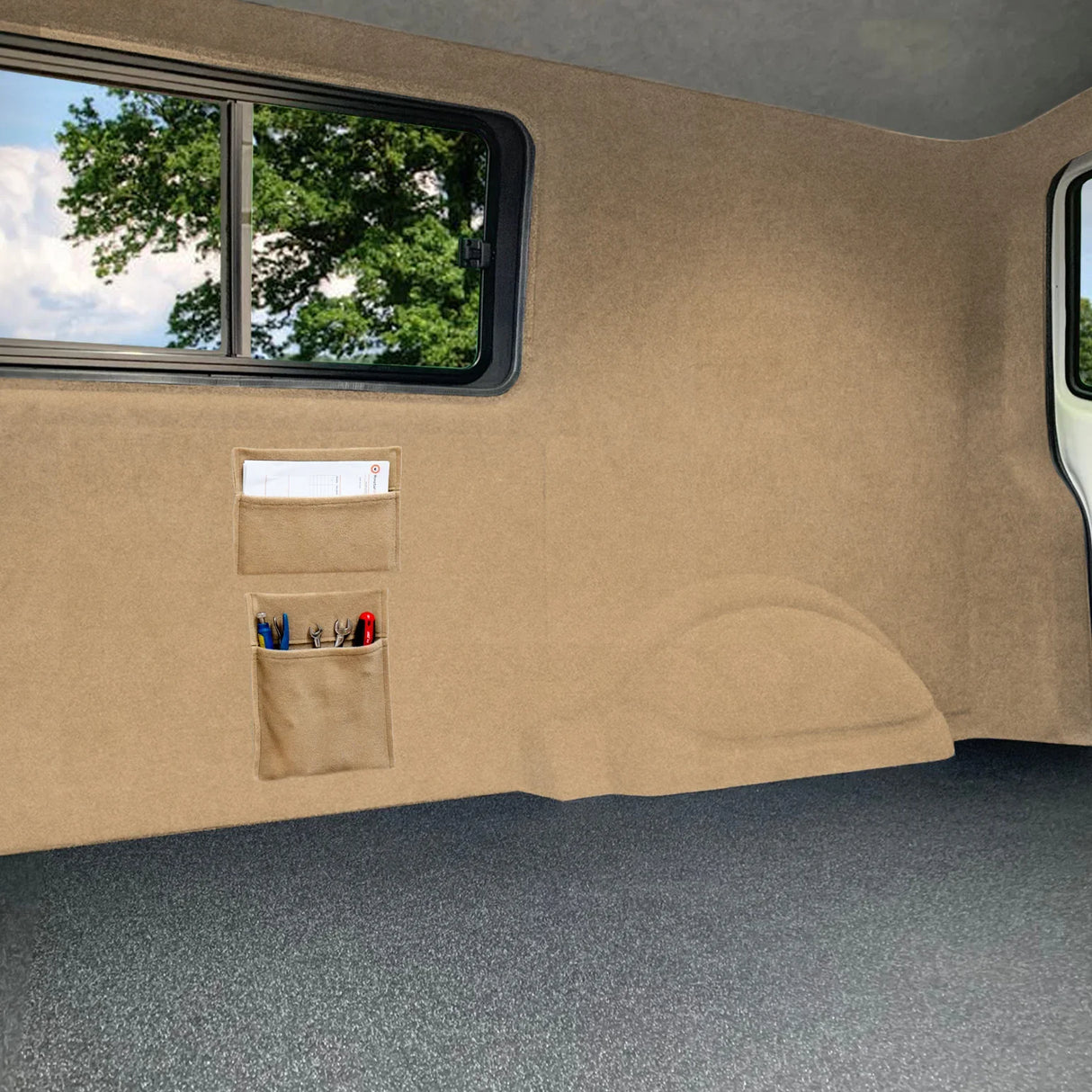 Beige van carpet lining with storage pouches, featuring a soft texture and a clean, organized interior space for essentials