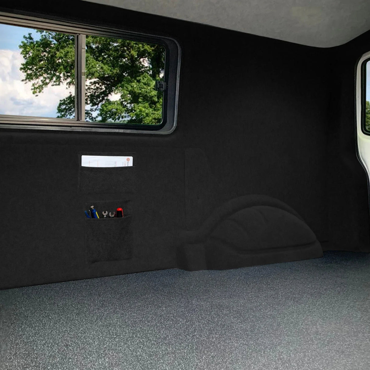 Black van carpet lining with storage pouches and adhesive glue, featuring a smooth texture and a seamless fit for enhanced organization
