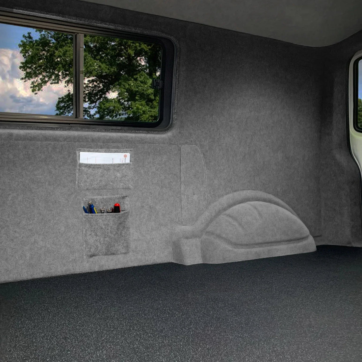 Smoke grey van carpet lining with textured finish, featuring storage pouches and adhesive glue for easy installation and organization