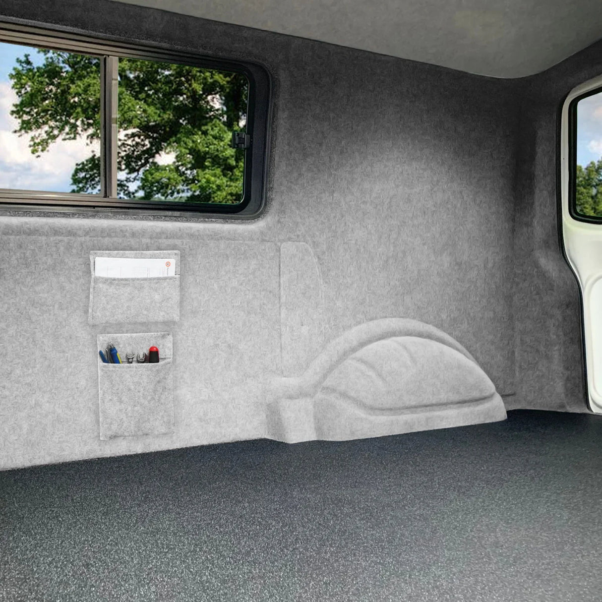 Silver grey van carpet lining with smooth texture, featuring storage pouches and adhesive glue for easy installation and organization