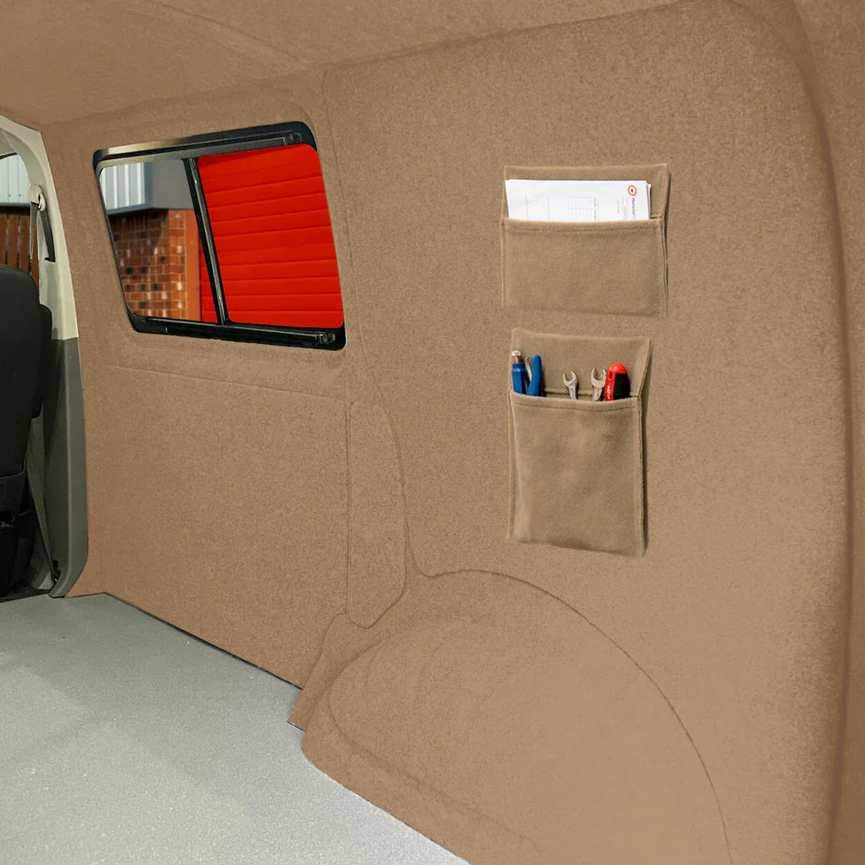 Beige van carpet lining with storage pouches, featuring a soft texture and practical design for organizing tools and documents