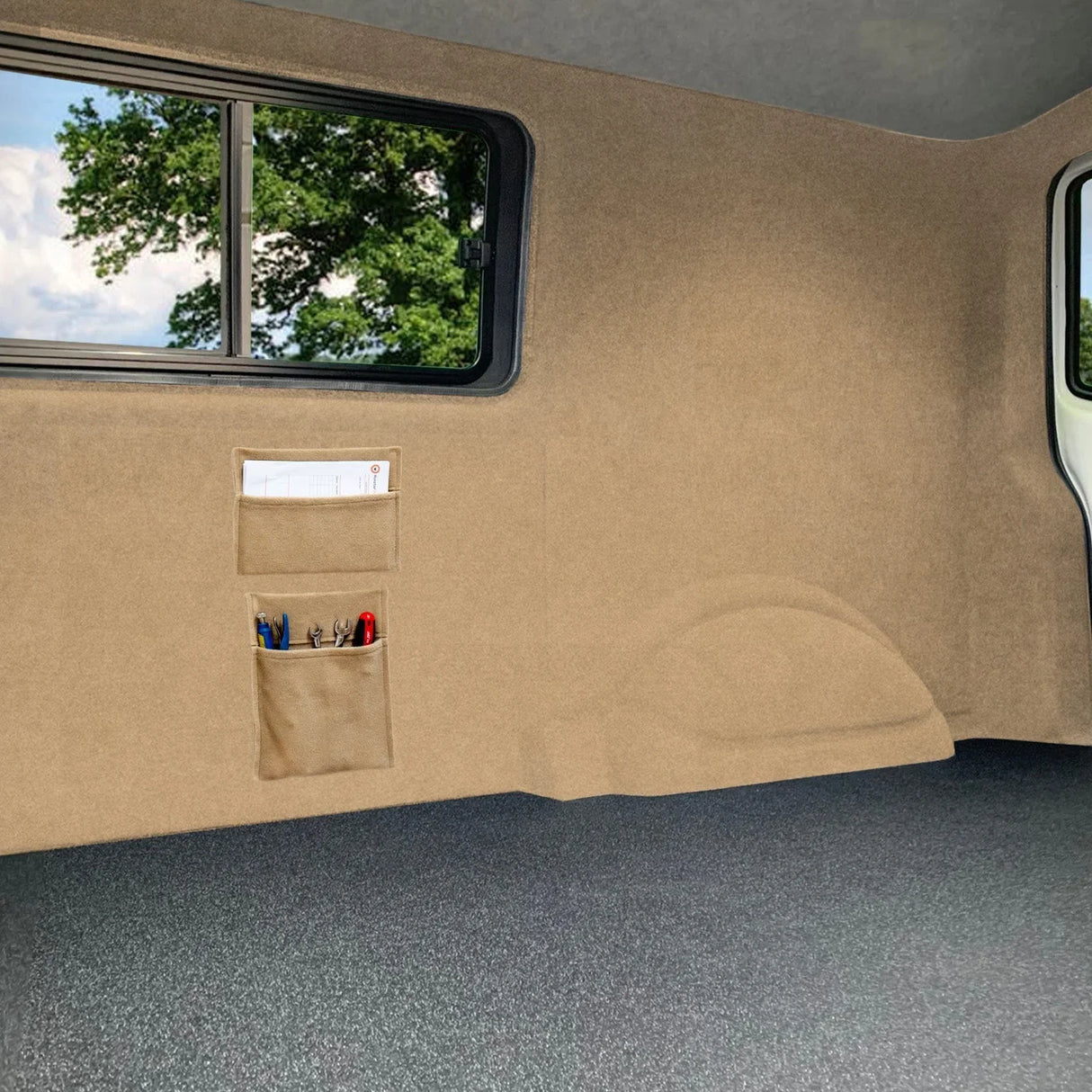 Beige van carpet lining with storage pouches attached to the wall, showcasing a soft texture and seamless fit for vehicle interiors