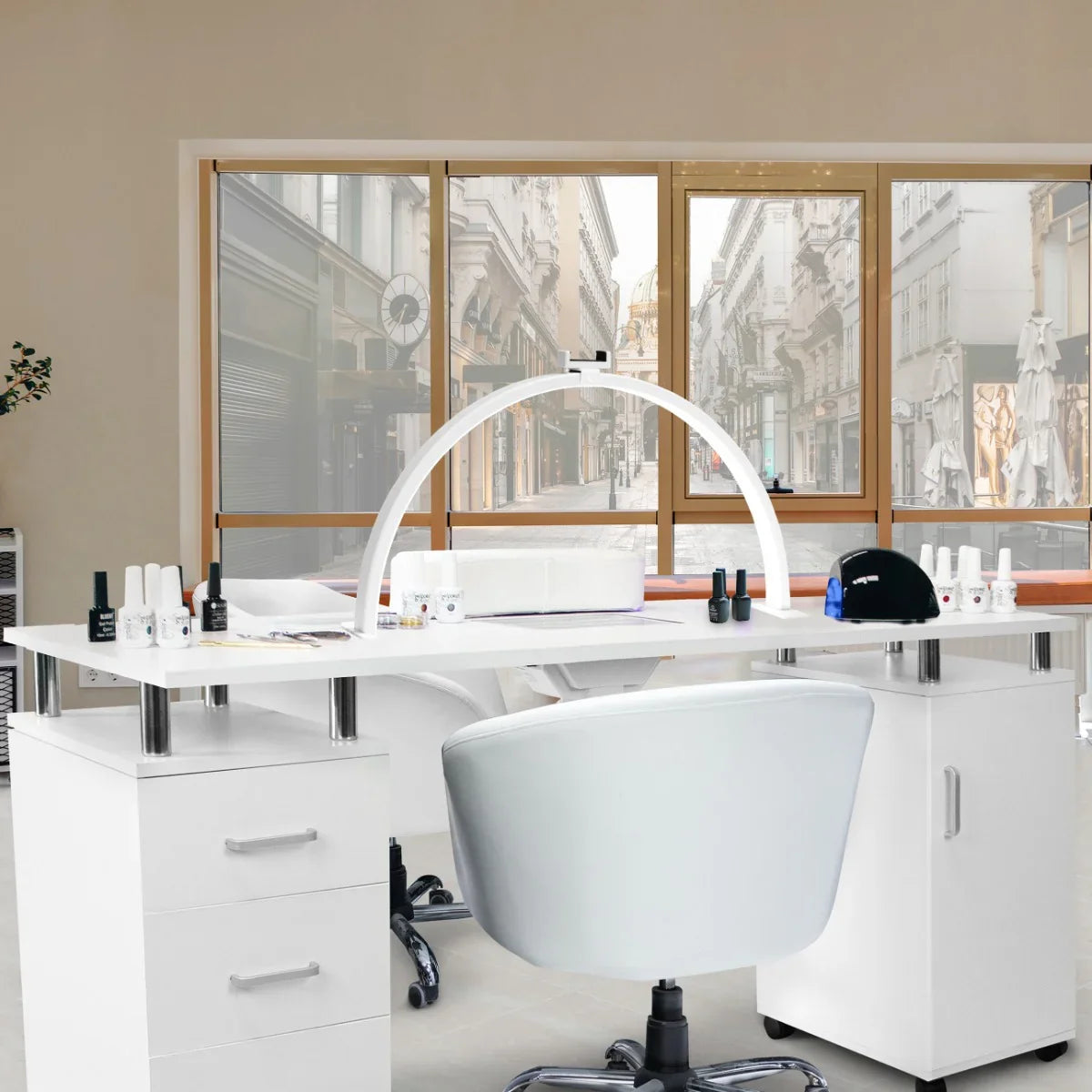 Sleek white professional manicure table with a curved LED half moon lamp, surrounded by nail polish bottles and a modern salon setting