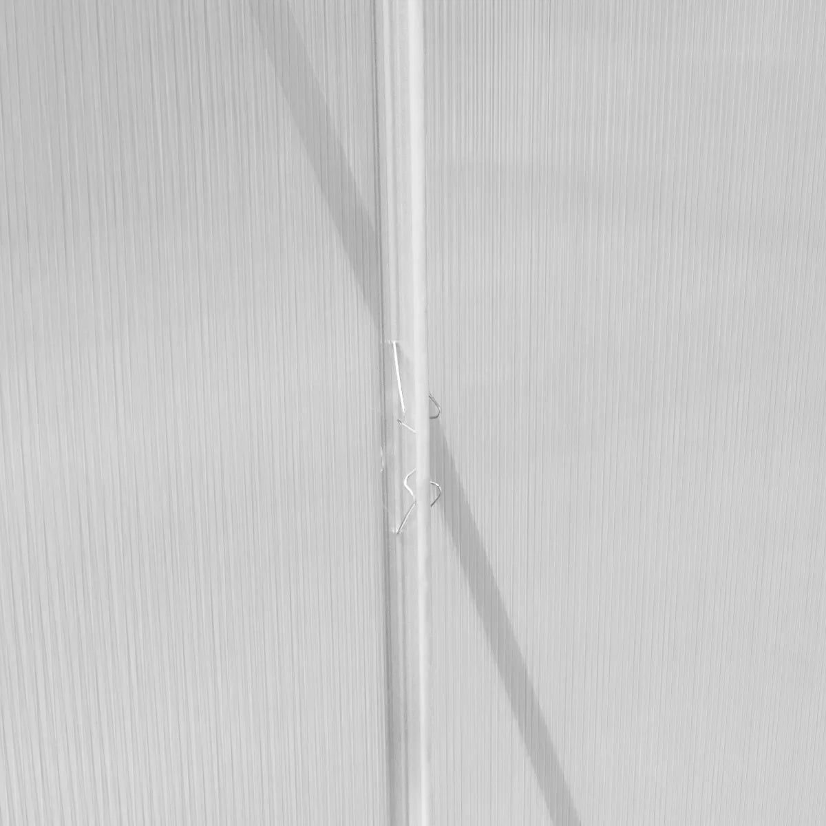 Close-up of the silver polycarbonate panels of a 6ft x 6ft greenhouse, showcasing the textured surface and light transmission features