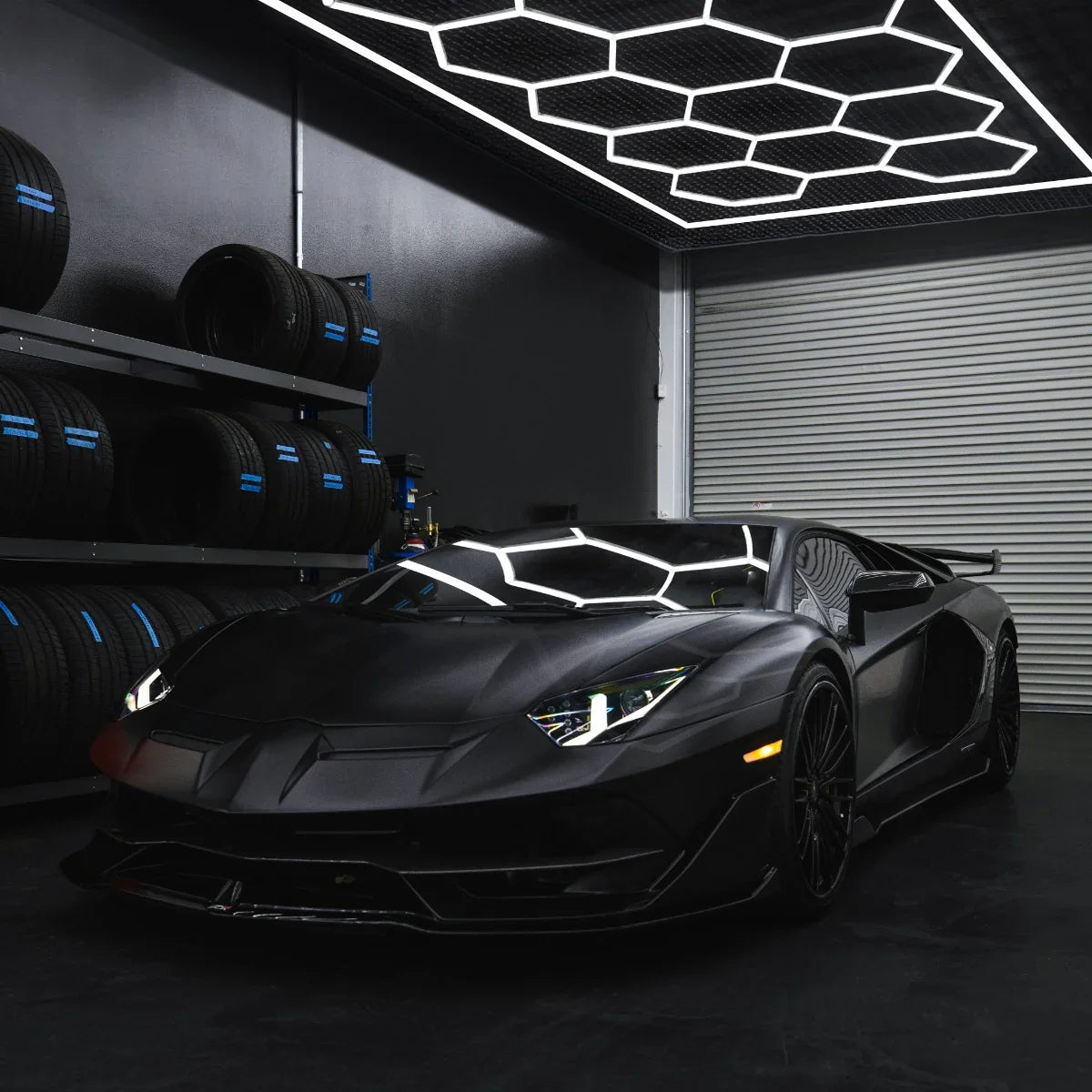 Hexagon LED lighting in a sleek black garage, illuminating a matte black sports car with sharp lines and modern design