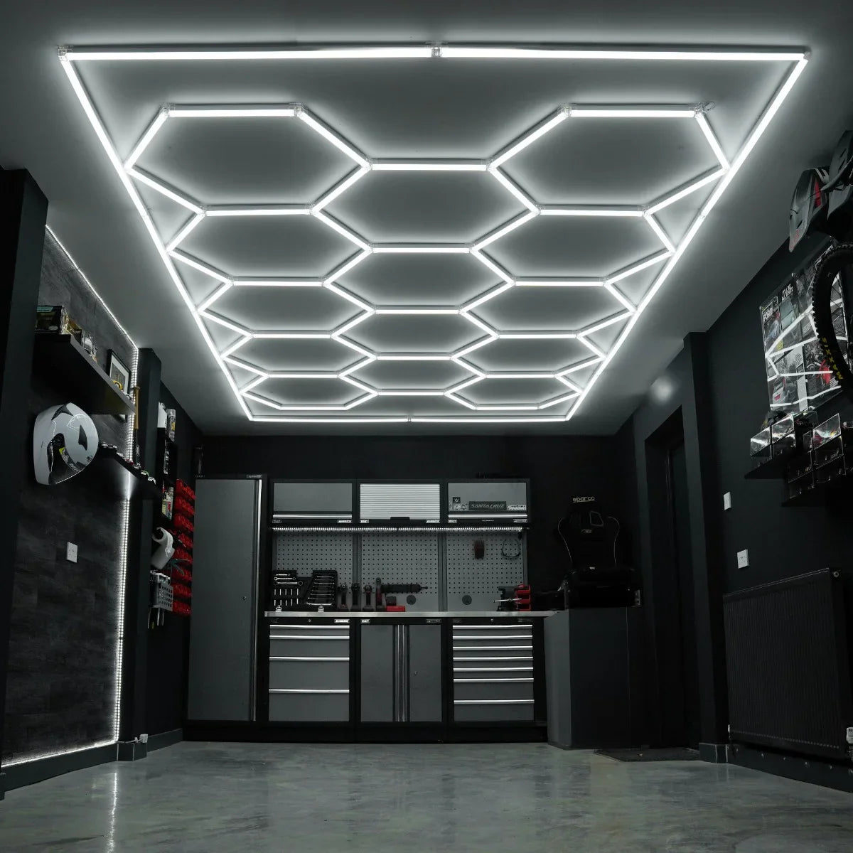 Hexagon LED lighting installation in a modern garage, featuring sleek white light strips on a dark ceiling and stylish cabinetry