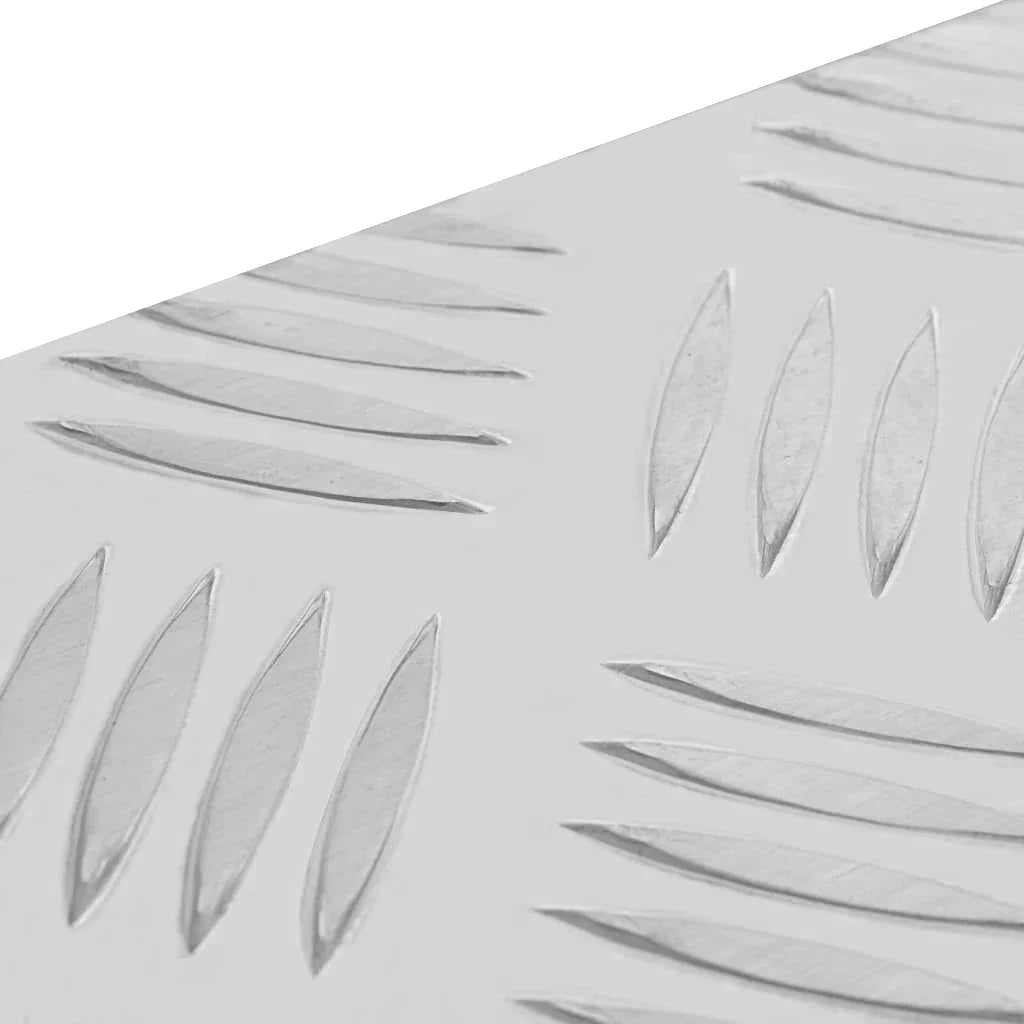 Textured aluminum surface of a 60L medium tool box, featuring a diamond plate design for enhanced grip and durability