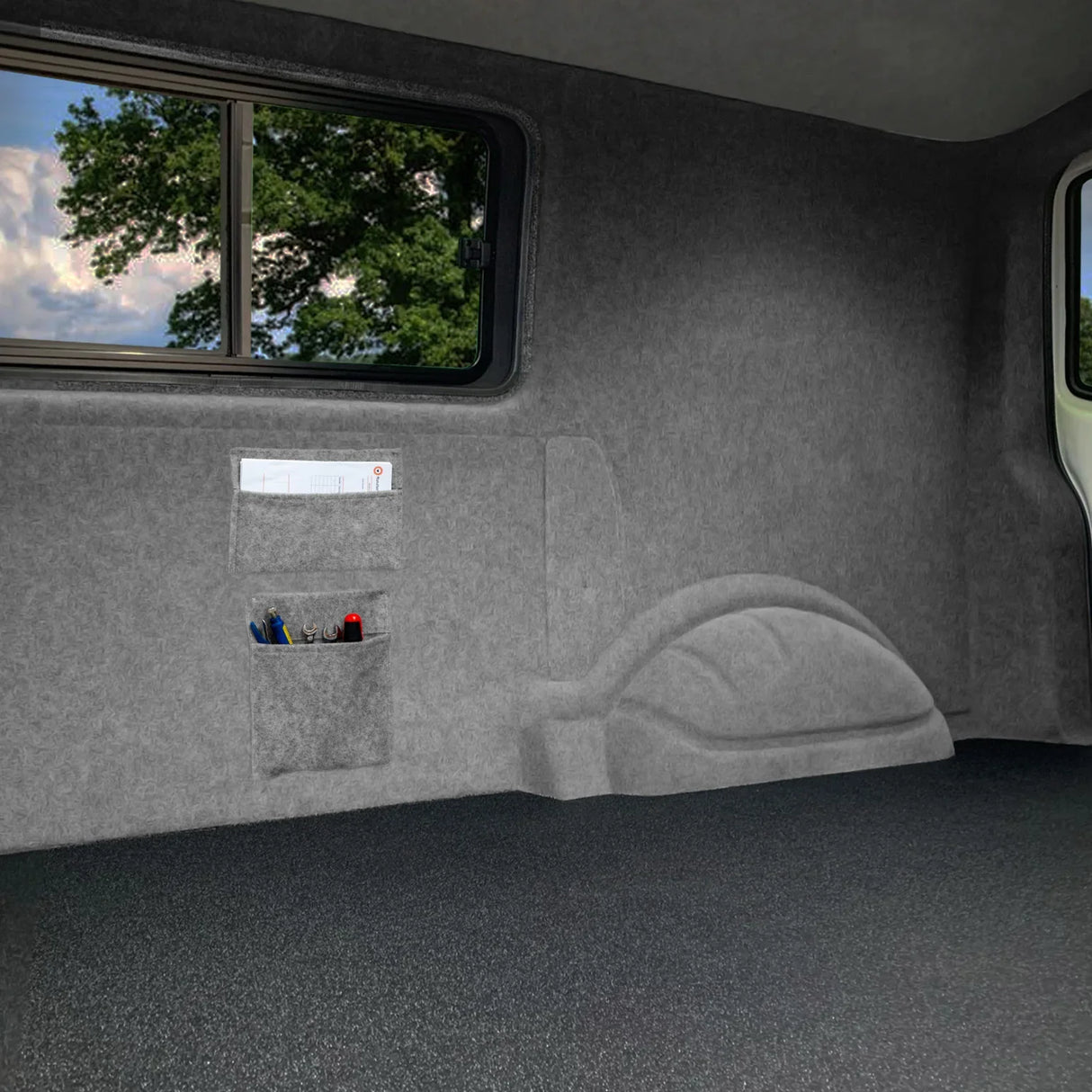 Smoke grey storage pouches with a soft texture, featuring multiple compartments for organization, set against a vehicle interior backdrop
