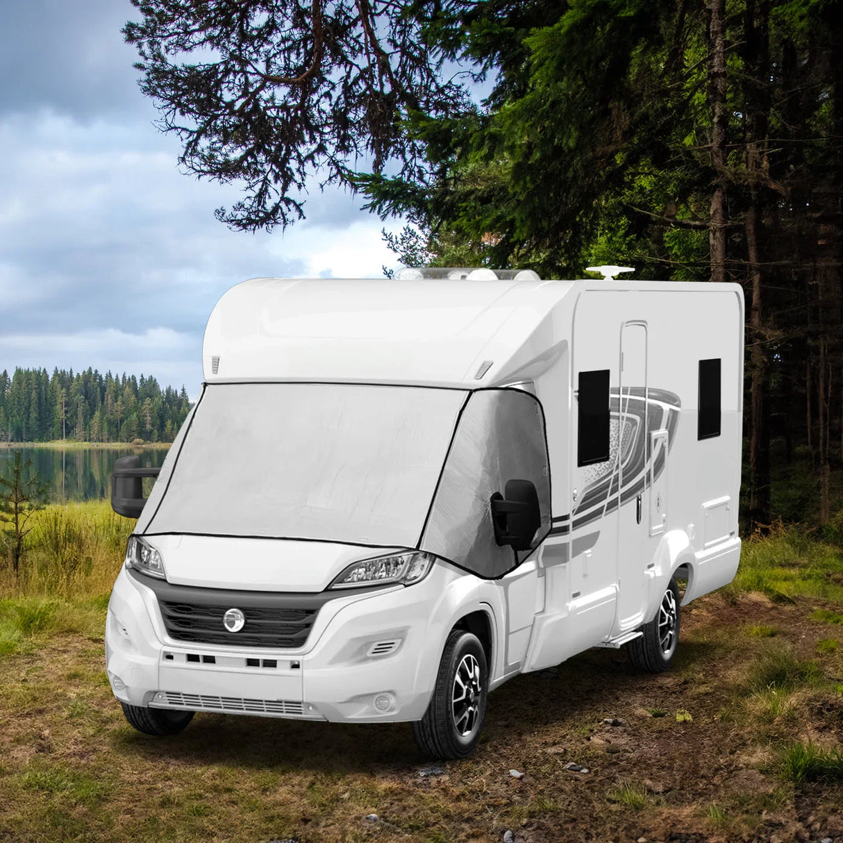 Motorhome screen cover displayed on a white camper van, set against a scenic forest backdrop with green trees and a lake