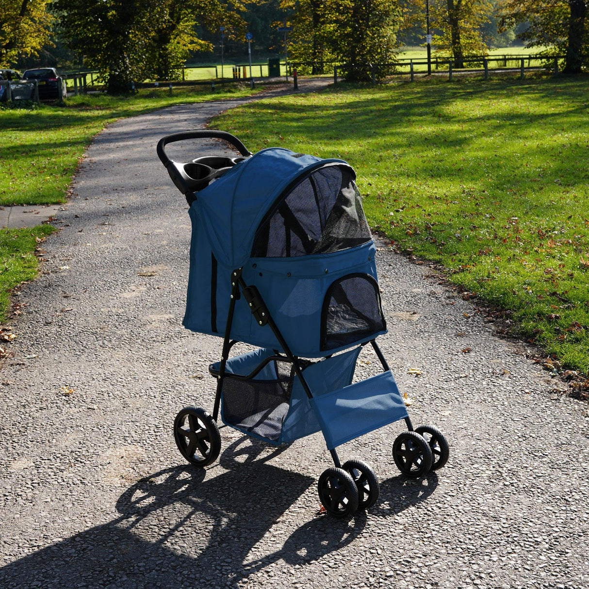 Navy blue pet stroller with rain cover, featuring mesh windows, sturdy wheels, and a spacious interior for comfortable travel