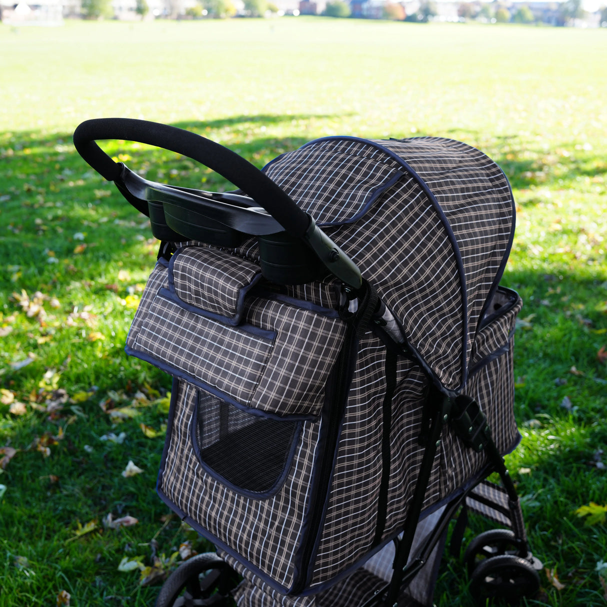 Blue tartan pet stroller caddy bag featuring a spacious design, mesh windows for ventilation, and a comfortable handle for easy maneuvering