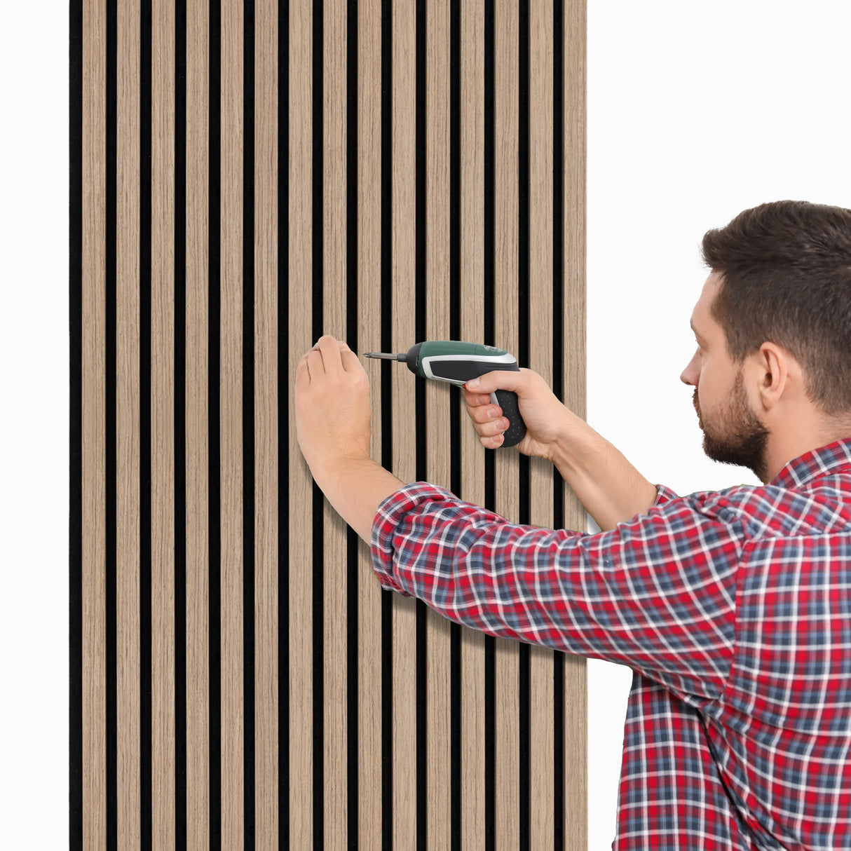 Light walnut acoustic slat wall panel being installed, featuring vertical slats and a smooth wood finish, enhancing sound absorption