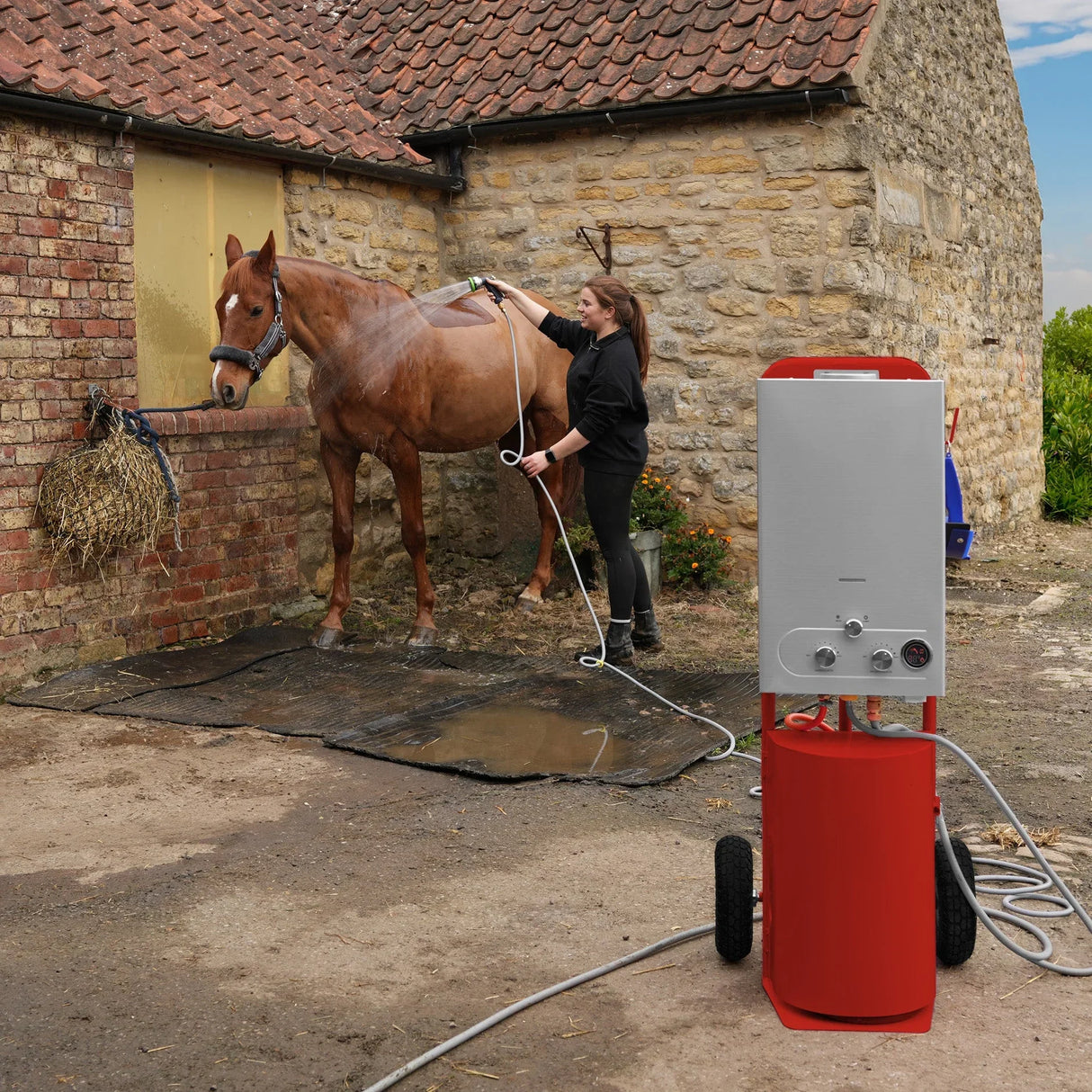 Deluxe Portable Horse Shower in red, featuring a sleek design, wheels for mobility, and a user washing a horse outdoors against a rustic backdrop
