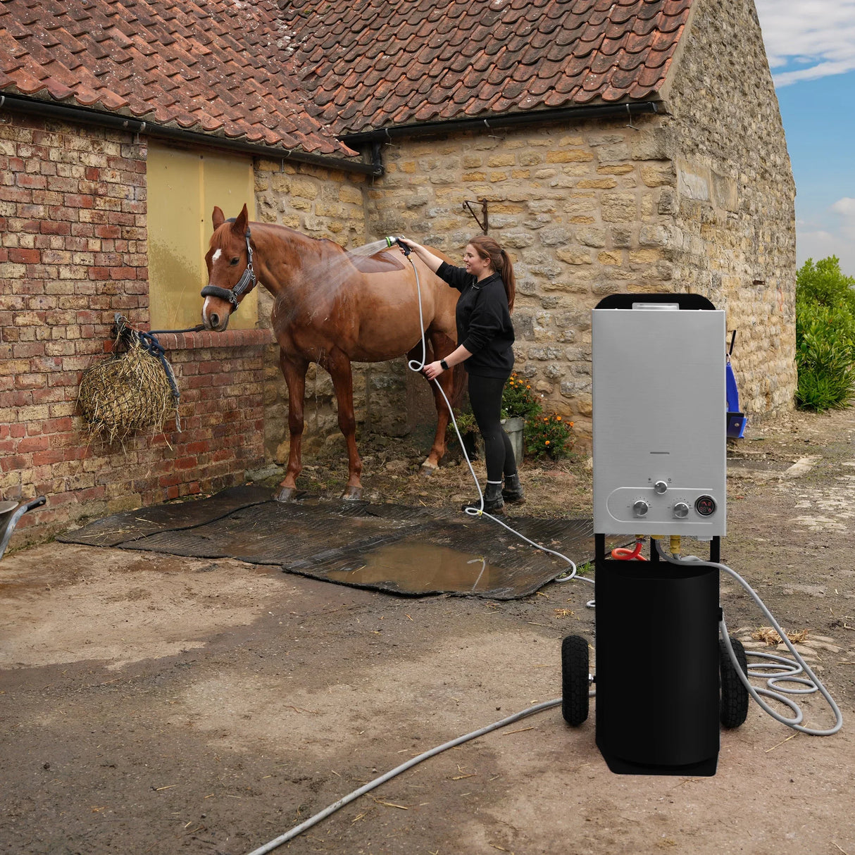 Deluxe Portable Horse Shower in black, featuring a sleek design, wheels for mobility, and a user washing a horse outdoors
