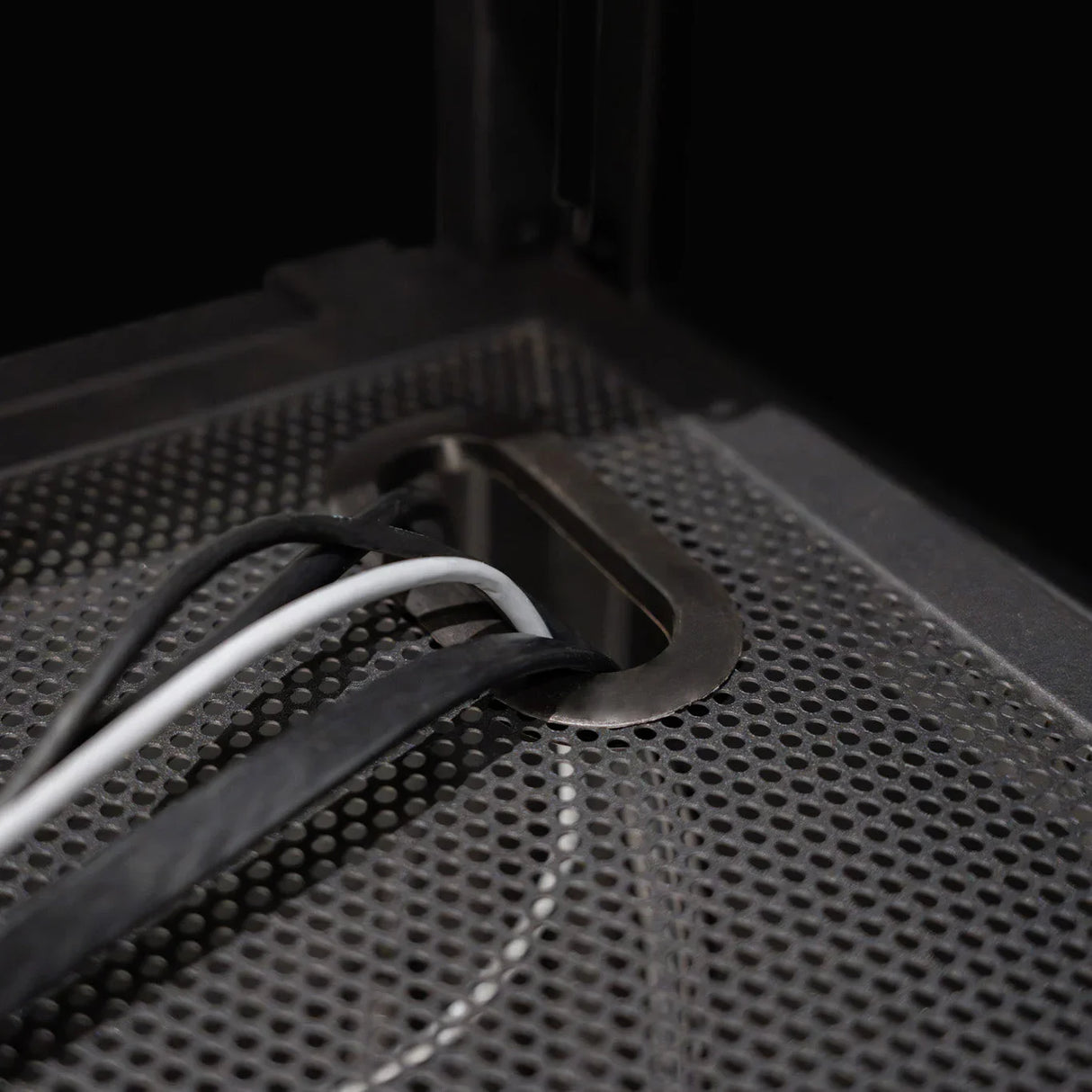 DJ Disco Booth Pro features a sleek metal cable management system with black and white cables neatly routed through a perforated surface