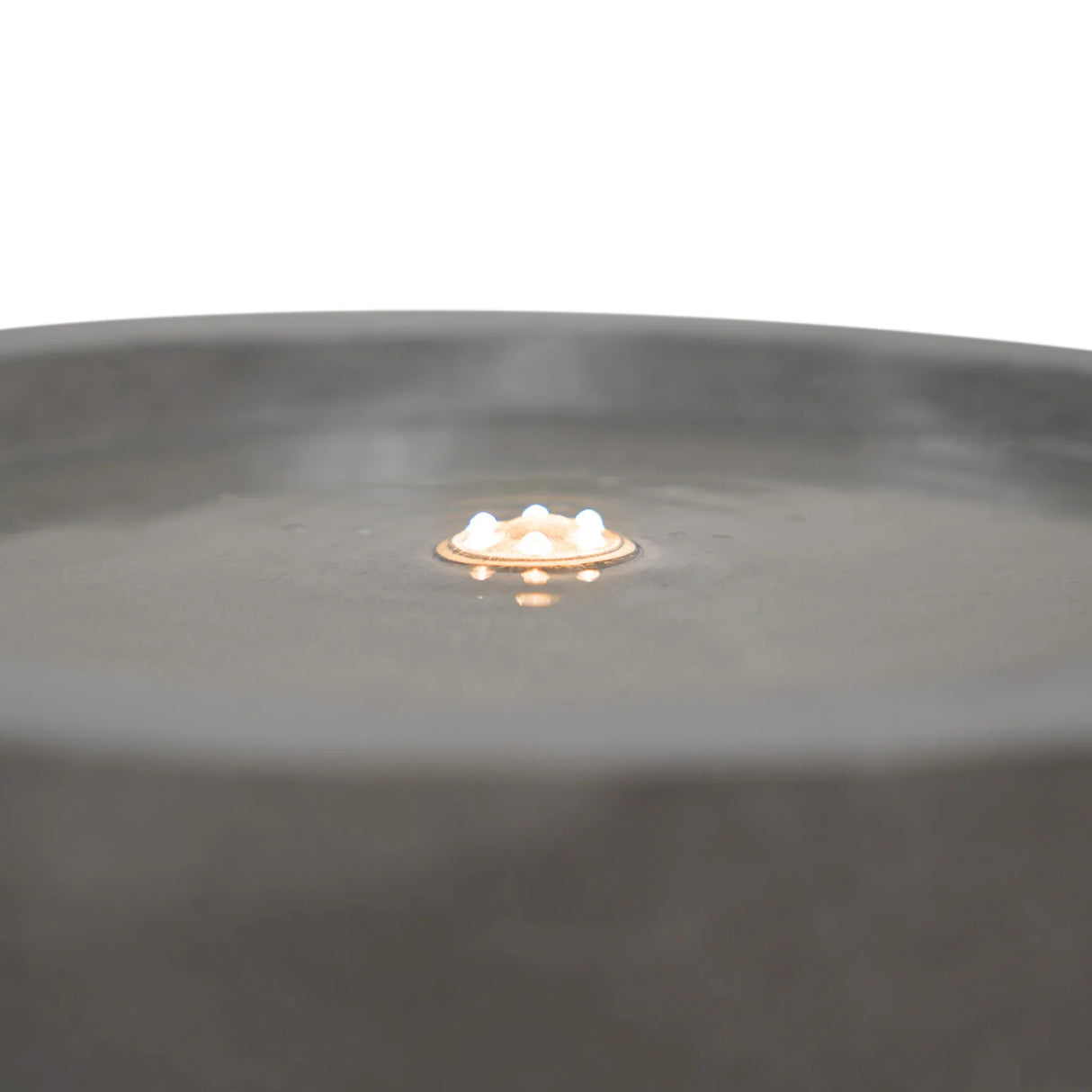 Serenity Falls electric water feature with a smooth gray basin, gentle water ripple, and soft glowing light in the center