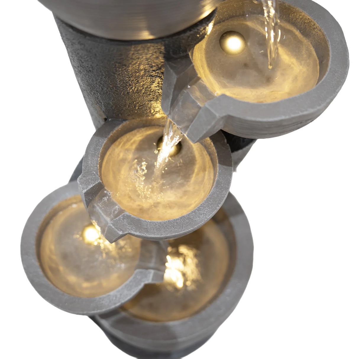 Electric water feature with four cascading bowls, illuminated by soft lights, showcasing a sleek gray finish and flowing water
