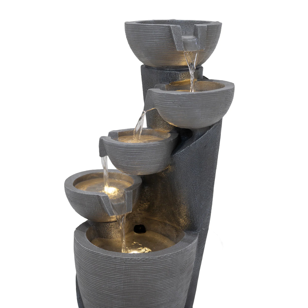 Electric water feature with four cascading bowls, textured gray finish, illuminated by warm lights, creating a serene ambiance