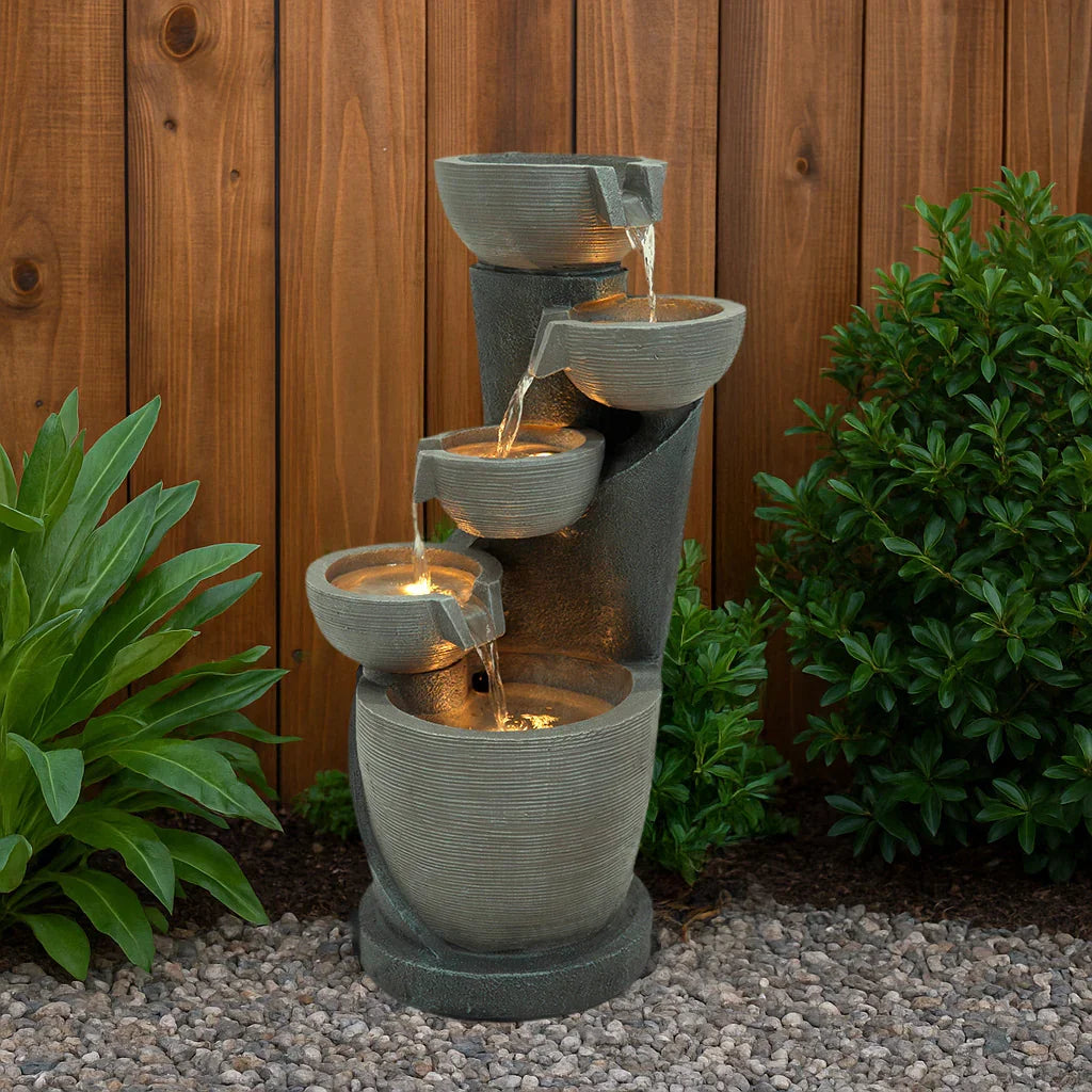 Electric water feature Illusion Lagoon with cascading bowls, textured stone finish, and illuminated water flow against wooden backdrop