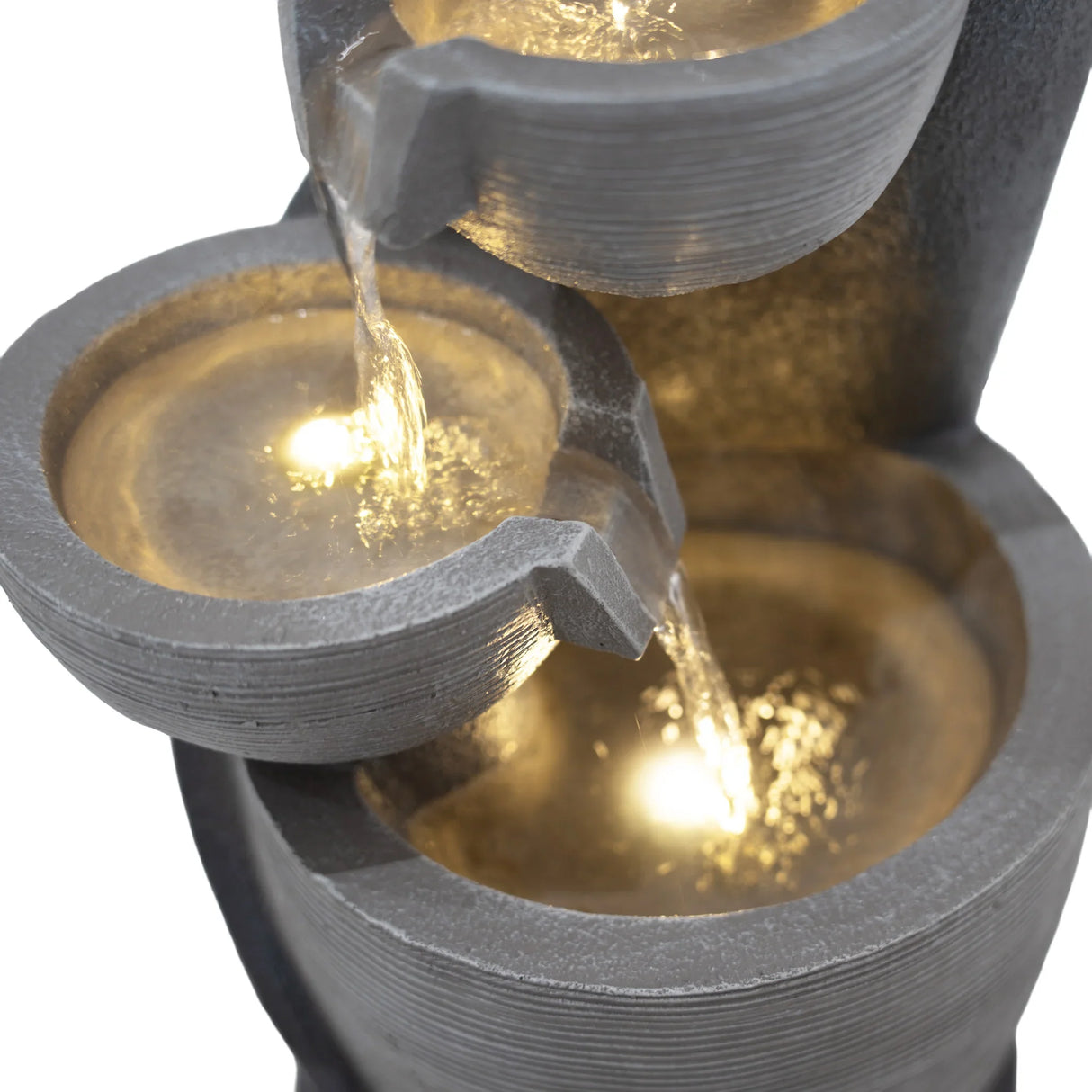 Electric water feature with three textured bowls, cascading water illuminated by soft lights, creating a serene ambiance
