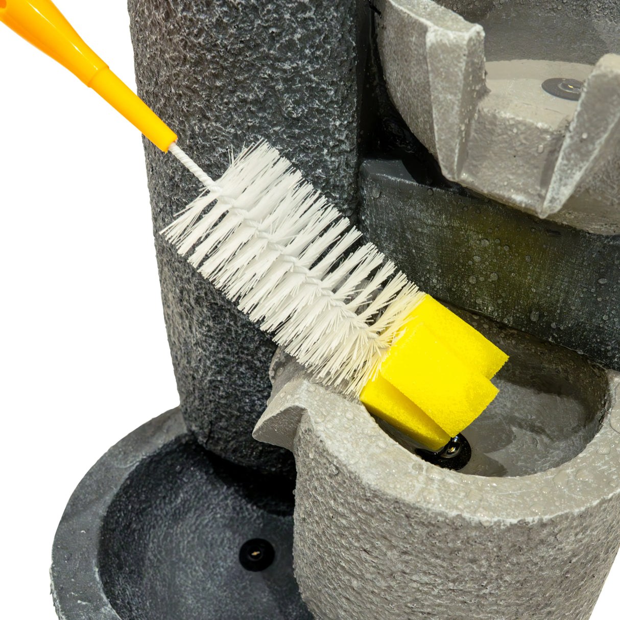 Close-up of the Electric Water Feature - Tranquil Tiers, showcasing a cleaning brush in a textured gray basin with flowing water