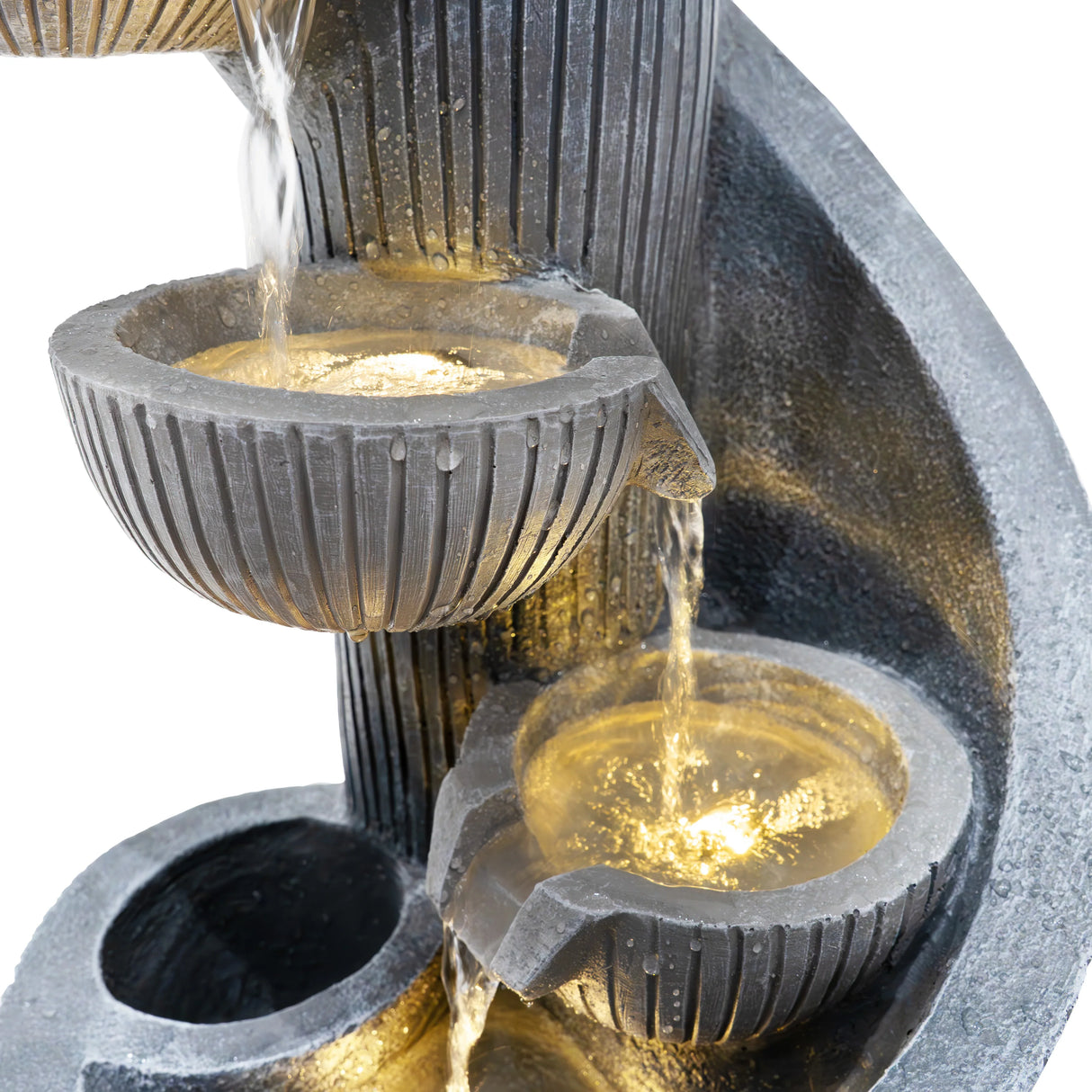 Electric water feature with spiral springs, featuring textured gray stone, cascading water, and illuminated bowls for a serene ambiance
