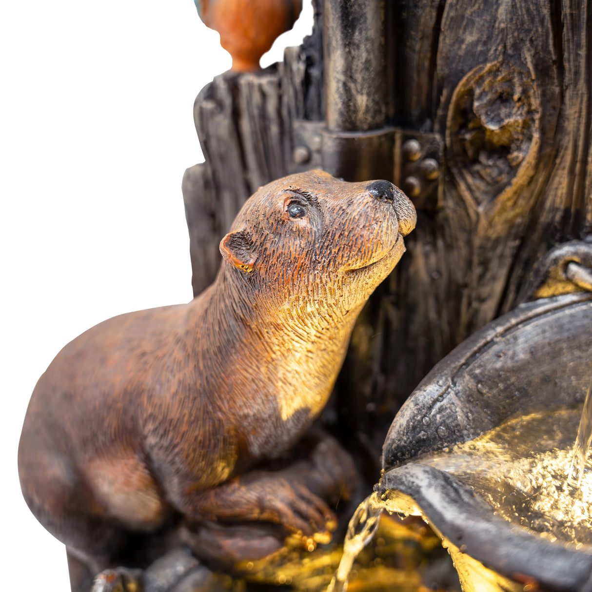Realistic otter sculpture beside a flowing water feature, showcasing intricate textures and warm brown tones in a serene garden setting