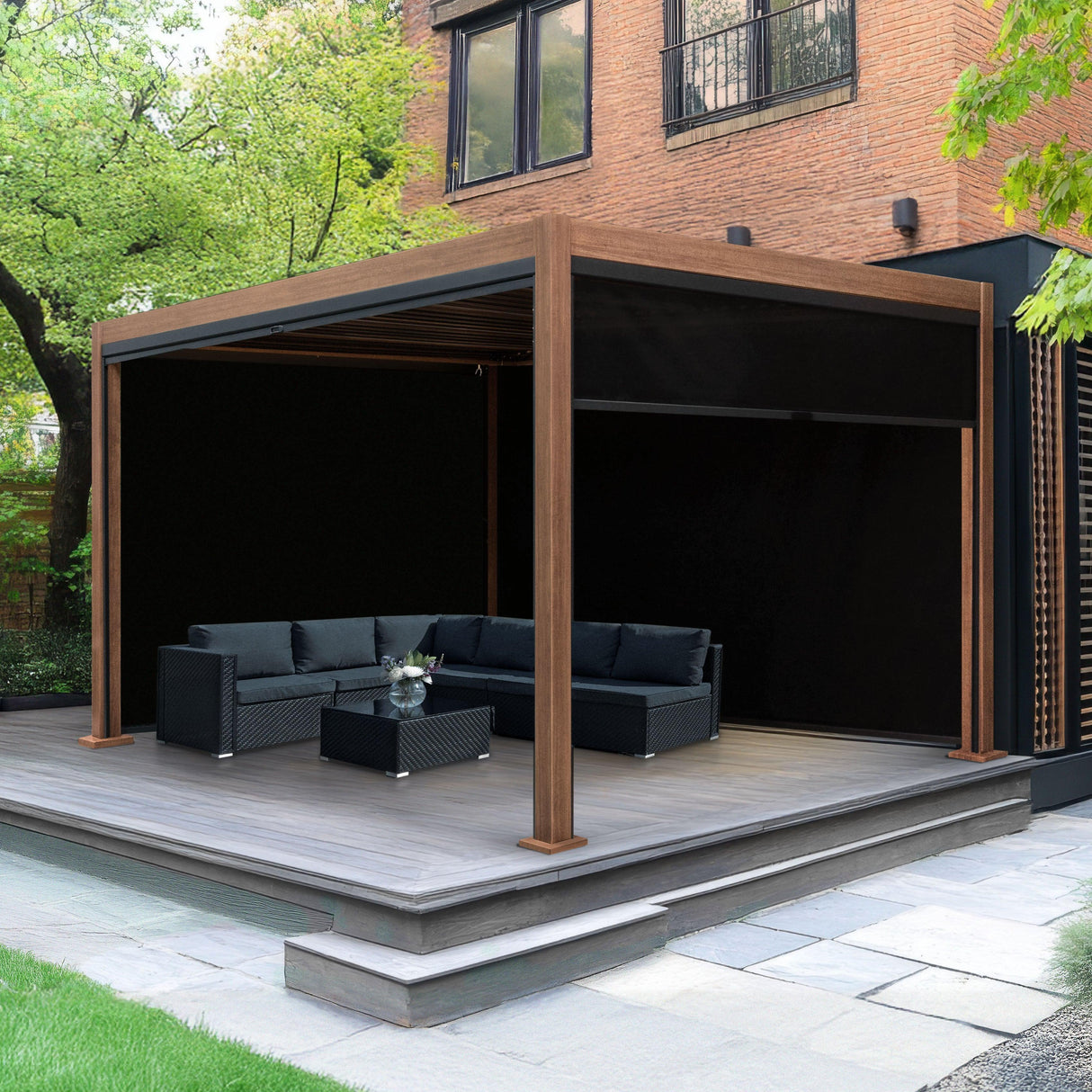 Wood effect aluminium pergola with blinds, featuring a spacious outdoor seating area, dark cushions, and a sleek wooden frame