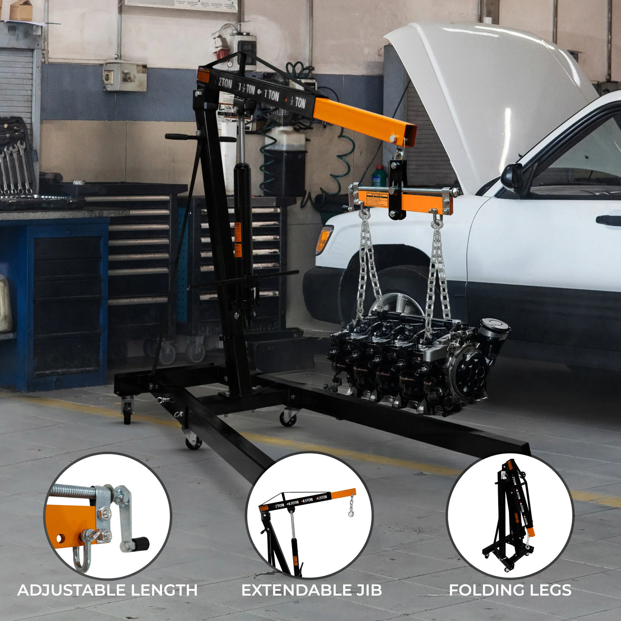Heavy-duty engine crane with adjustable length, extendable jib, and folding legs, lifting an engine in a garage setting