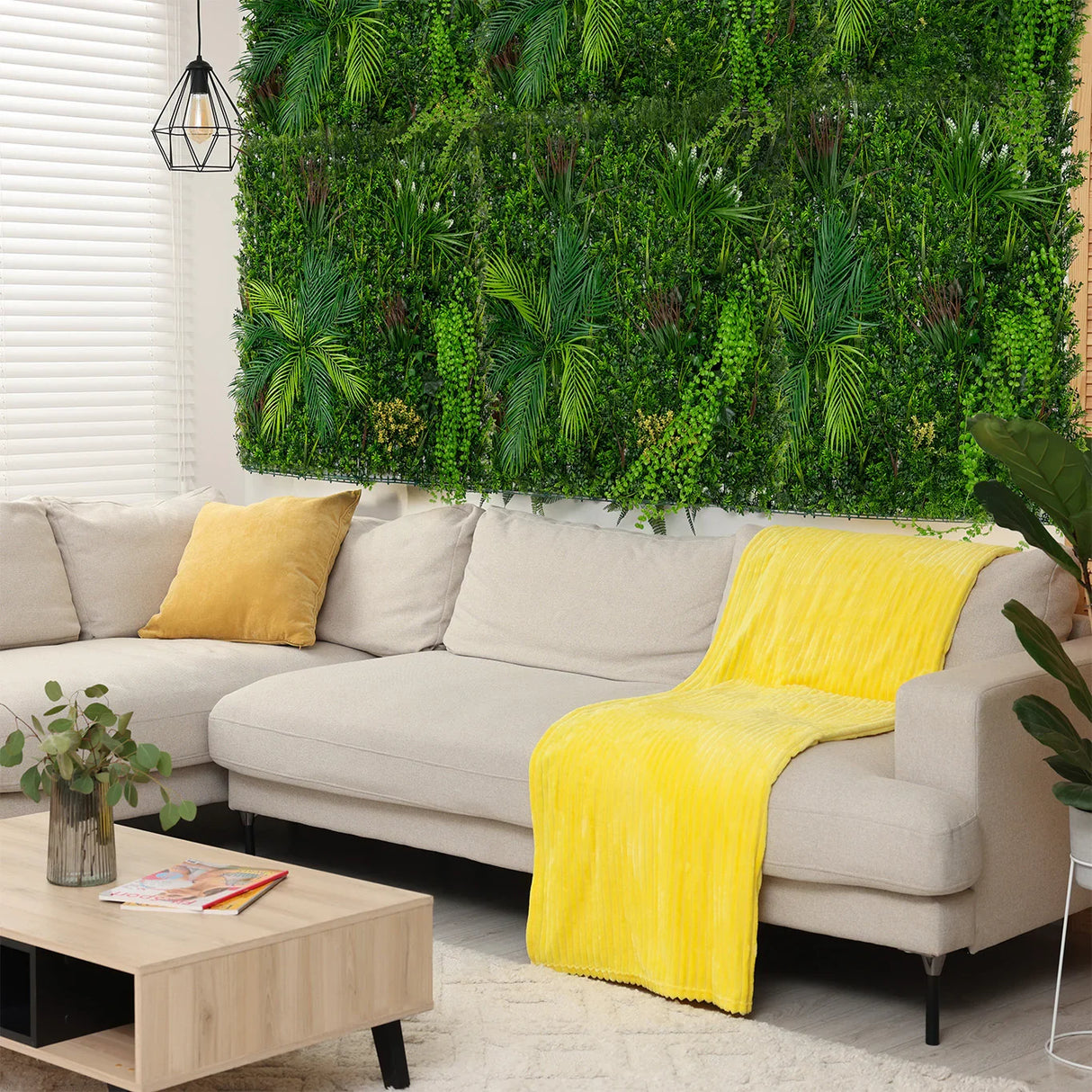 Lush green Alina Artificial Wall Tile, 100cm x 100cm, enhances a cozy living room with vibrant yellow throw and soft beige sofa