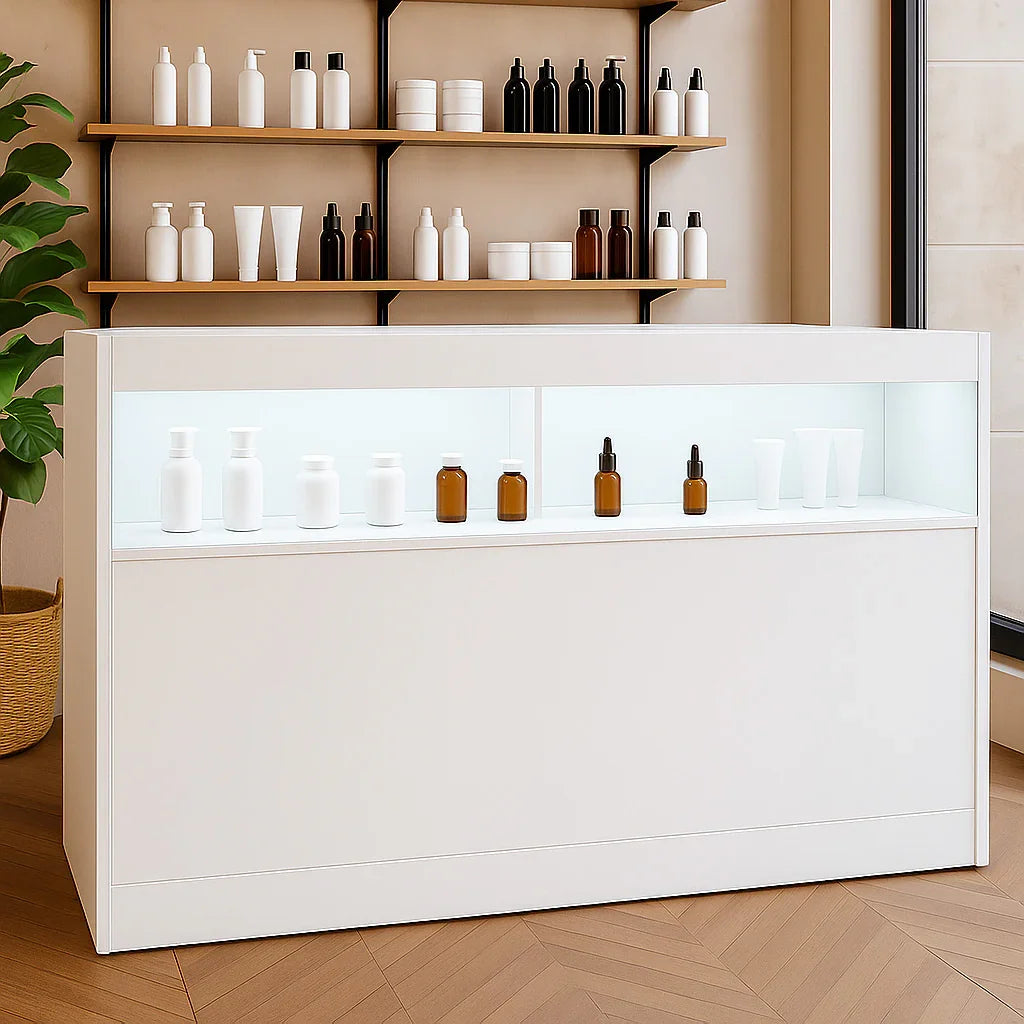 LED retail shop counter B1500 in white, featuring illuminated display shelves with various bottles and jars, set in a modern shop interior