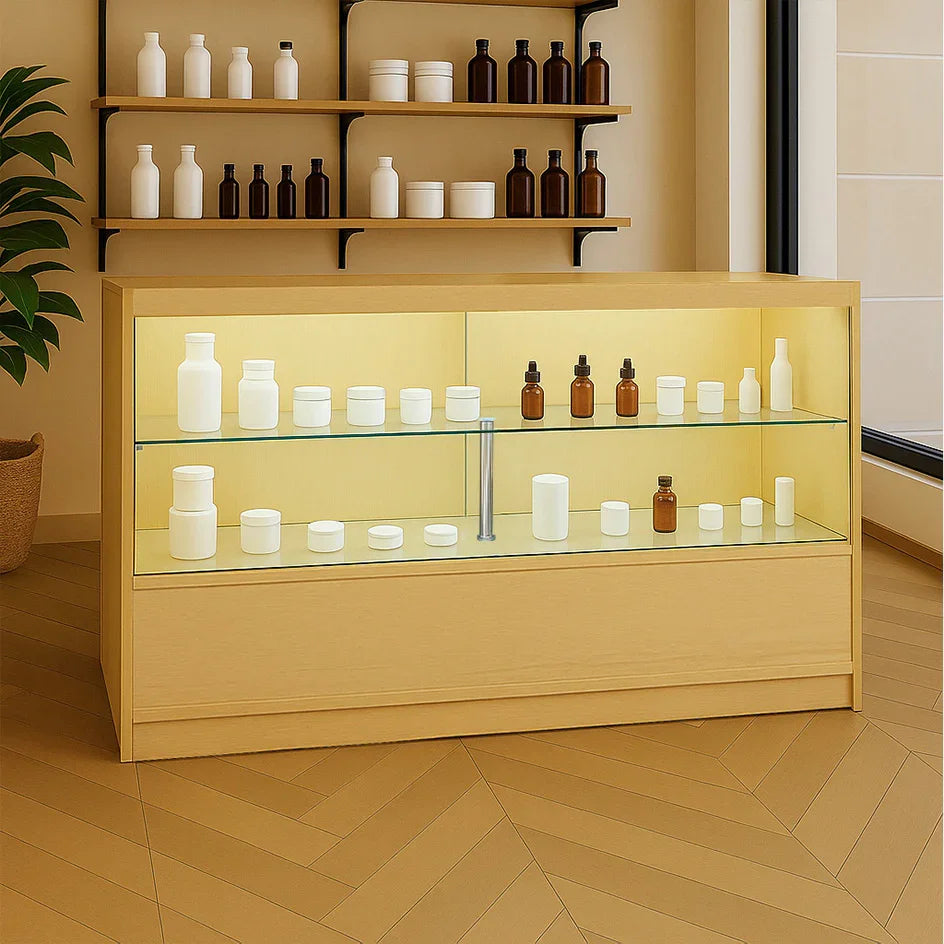 LED retail shop counter in maple finish with glass shelves, displaying various bottles and jars in a modern, bright setting