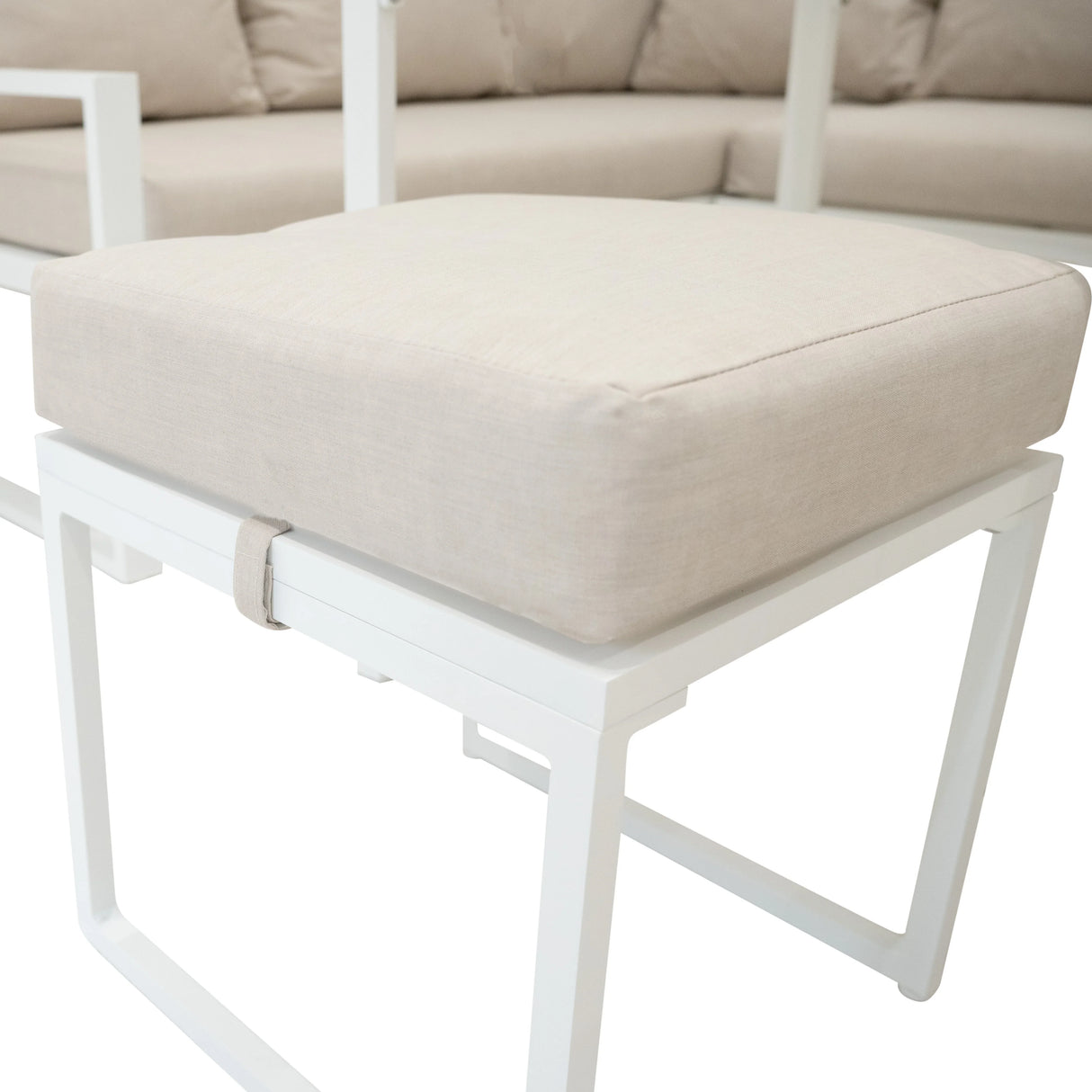 Aluminium corner sofa set in white with a soft beige cushion, featuring a modern design and sleek metal frame for outdoor elegance
