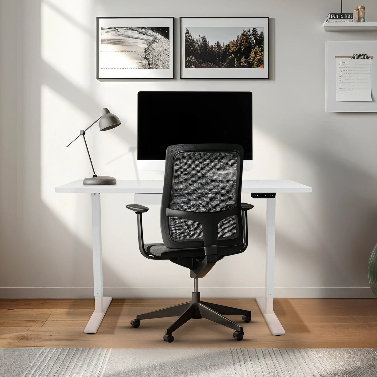 Electric standing desk with a sleek white finish, integrated drawer, and ergonomic black office chair in a modern workspace setting