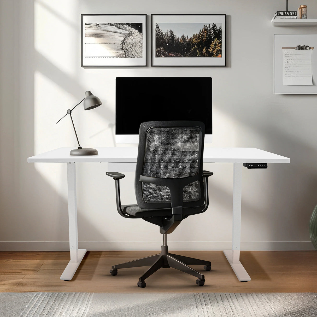 Electric standing desk with white surface, adjustable height, sleek design, accompanied by a modern black office chair and stylish decor